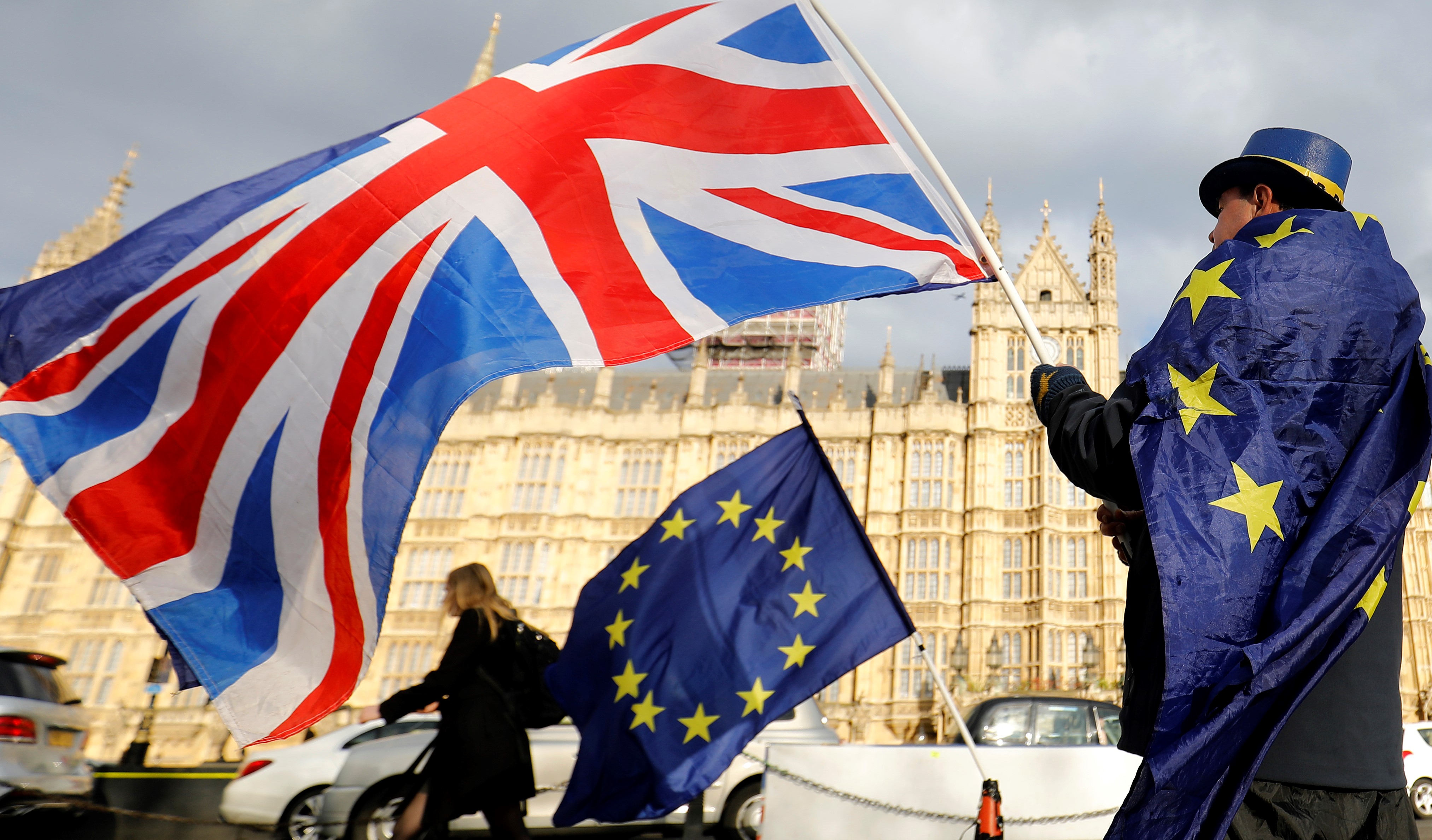  An anti-Brexit demonstrator waves a Union flag alongside a European Union flag outside the Houses of Parliament in London