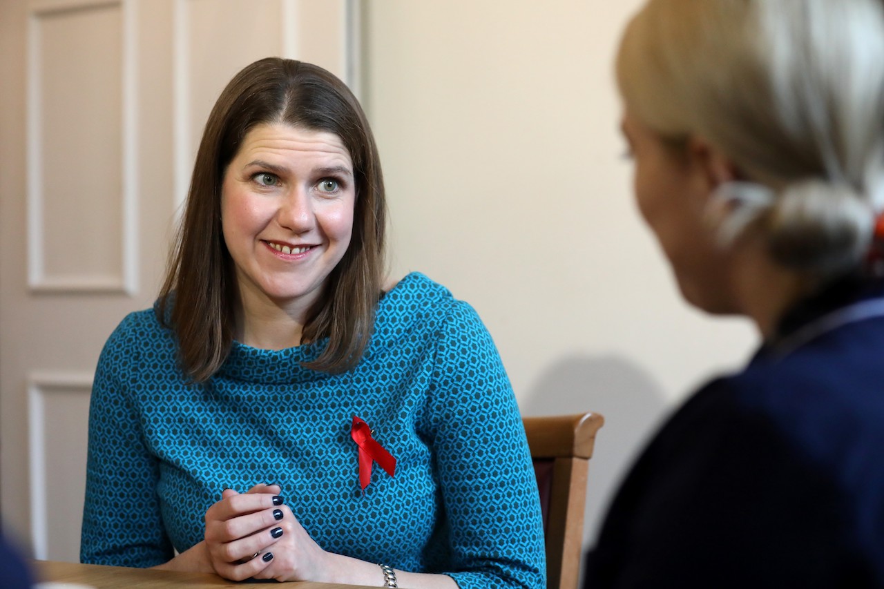 Britain's opposition Liberal Democrats leader Jo Swinson (L) reacts during a general election campaign visit to Bridge House Care Centre in Wallington, south of London (AFP)