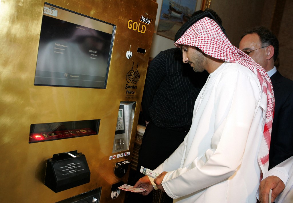 An Emirati man tries the "Gold to Go" vending machine at the Emirates Palace Hotel in Abu Dhabi in May 2010