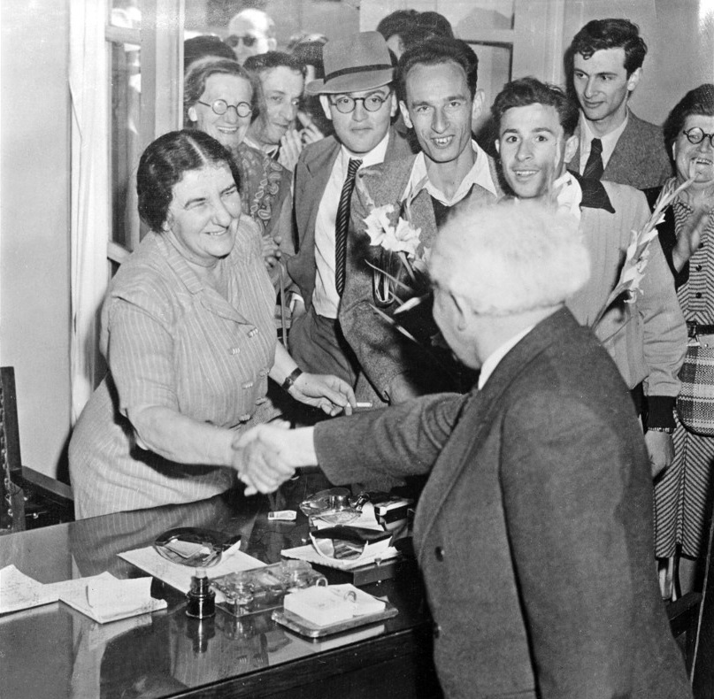 David Ben-Gurion shakes hands with Golda Meir in Tel Aviv in December 1947 (AFP)