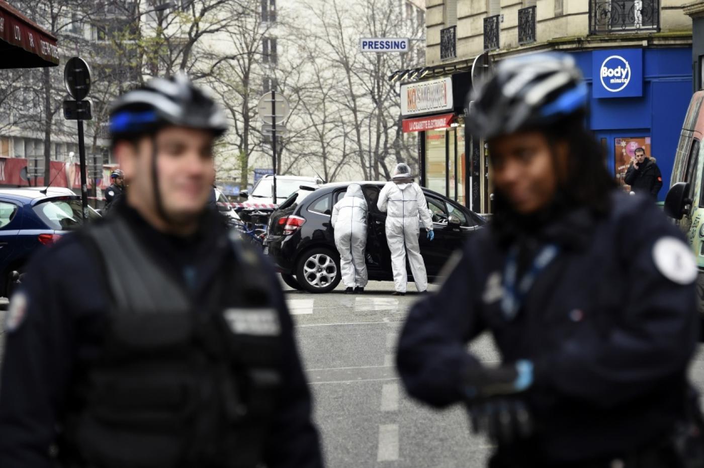 Police officers and forensic experts examine the car used by the gunmen who had stormed the Paris headquarters of the satirical newspaper Charlie Hebdo, killing 12 (AFP)