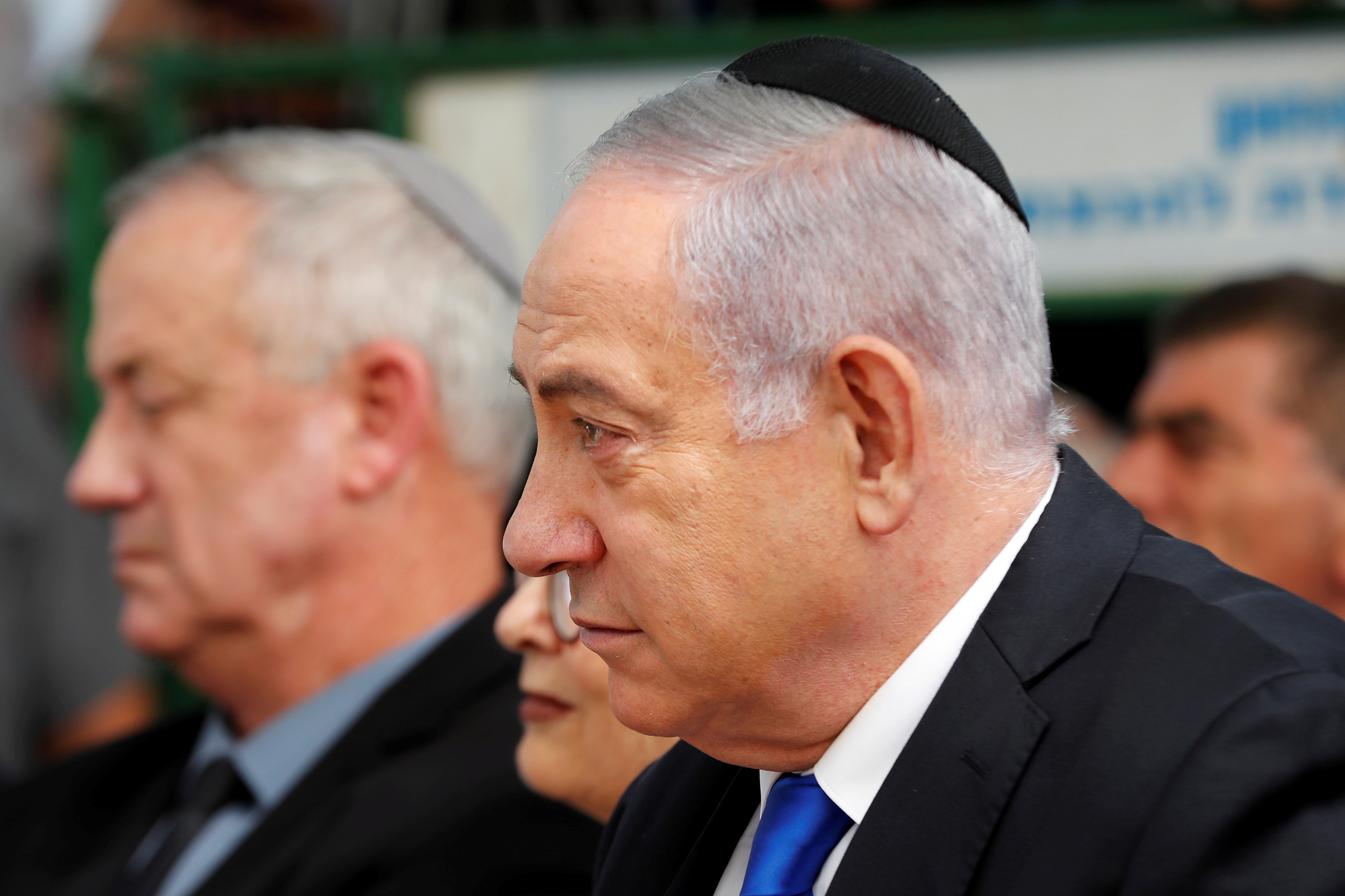 Israeli Prime Minister Benjamin Netanyahu sits next to Benny Gantz, leader of the Blue and White party on 22 September (Reuters)