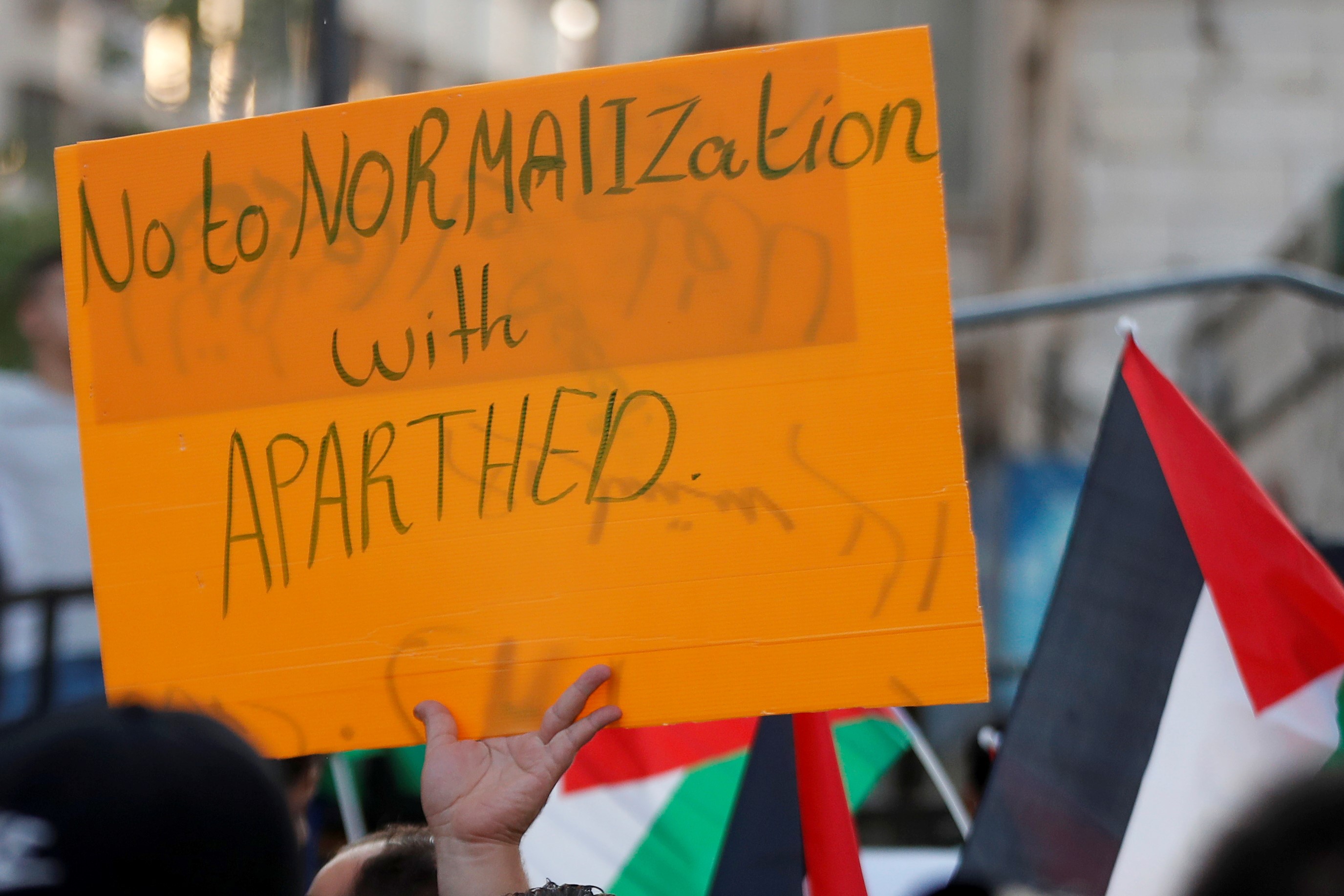 A Palestinian demonstrator holds a sign during a protest against the United Arab Emirates and Bahrain's deal with Israel to normalise relations, in Ramallah in the Israeli-occupied West Bank September 15, 2020