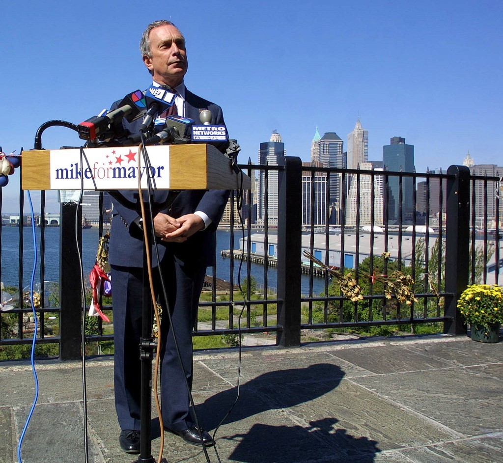 Michael Bloomberg, Republican candidate for New York mayor, speaks to the press in Brooklyn, New York, with lower Manhattan as a backdrop 26 September 2001.