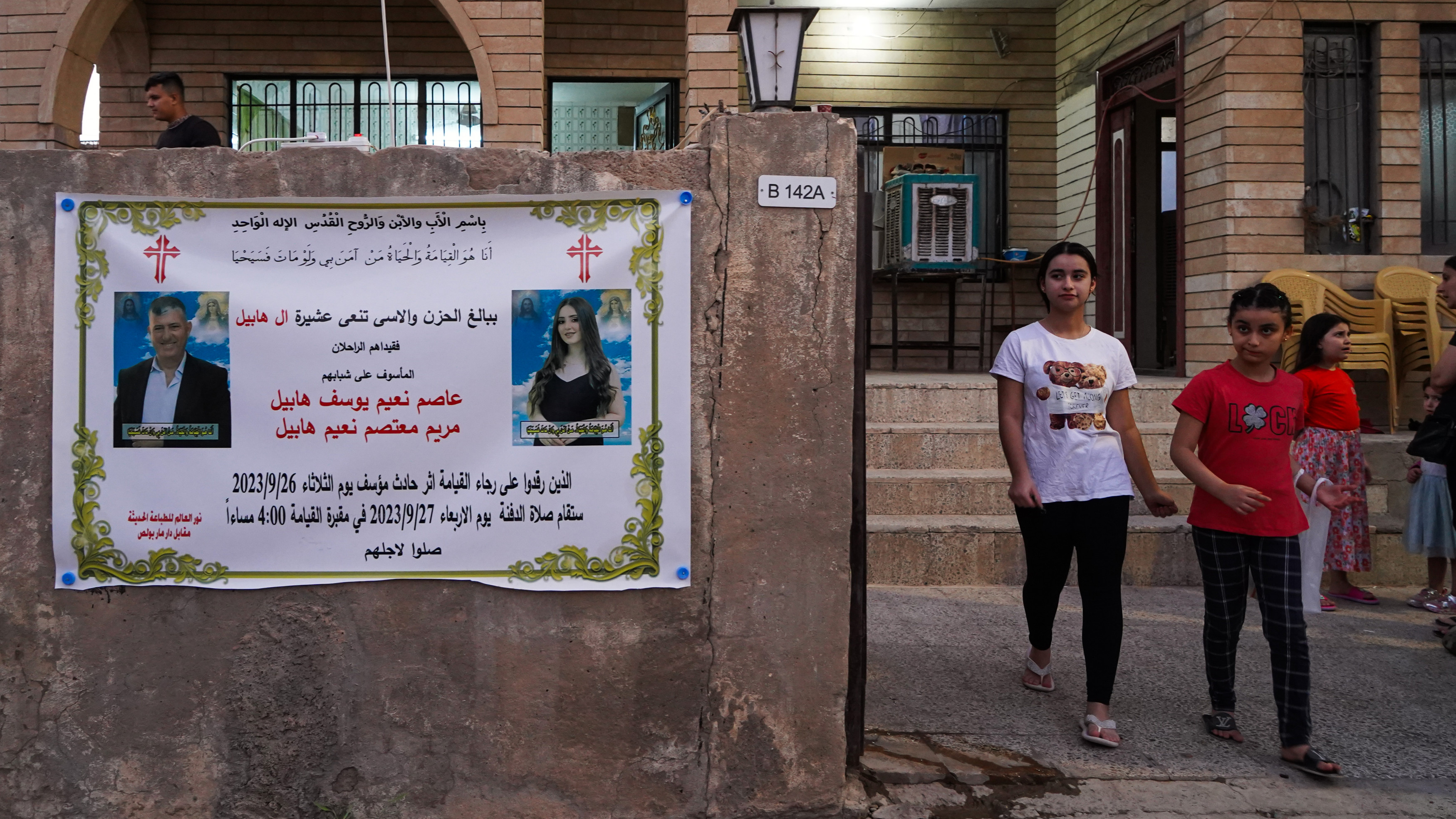 Poster of condolences for Maryam and her uncle Asem Naeem adorn a wall in Hamdaniya district (MEE/Ismael Adnan)