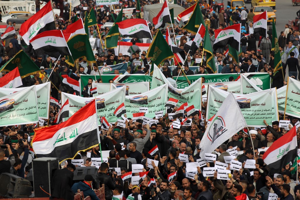 Iraqis protest in Baghdad’s Tahrir Square on 6 December (AFP)