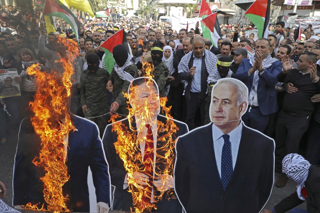 Palestinian protesters burn cardboard cutouts of Trump, US Secretary of State Mike Pompeo and Israeli Prime Minister Benjamin Netanyahu in Nablus in November (AFP)