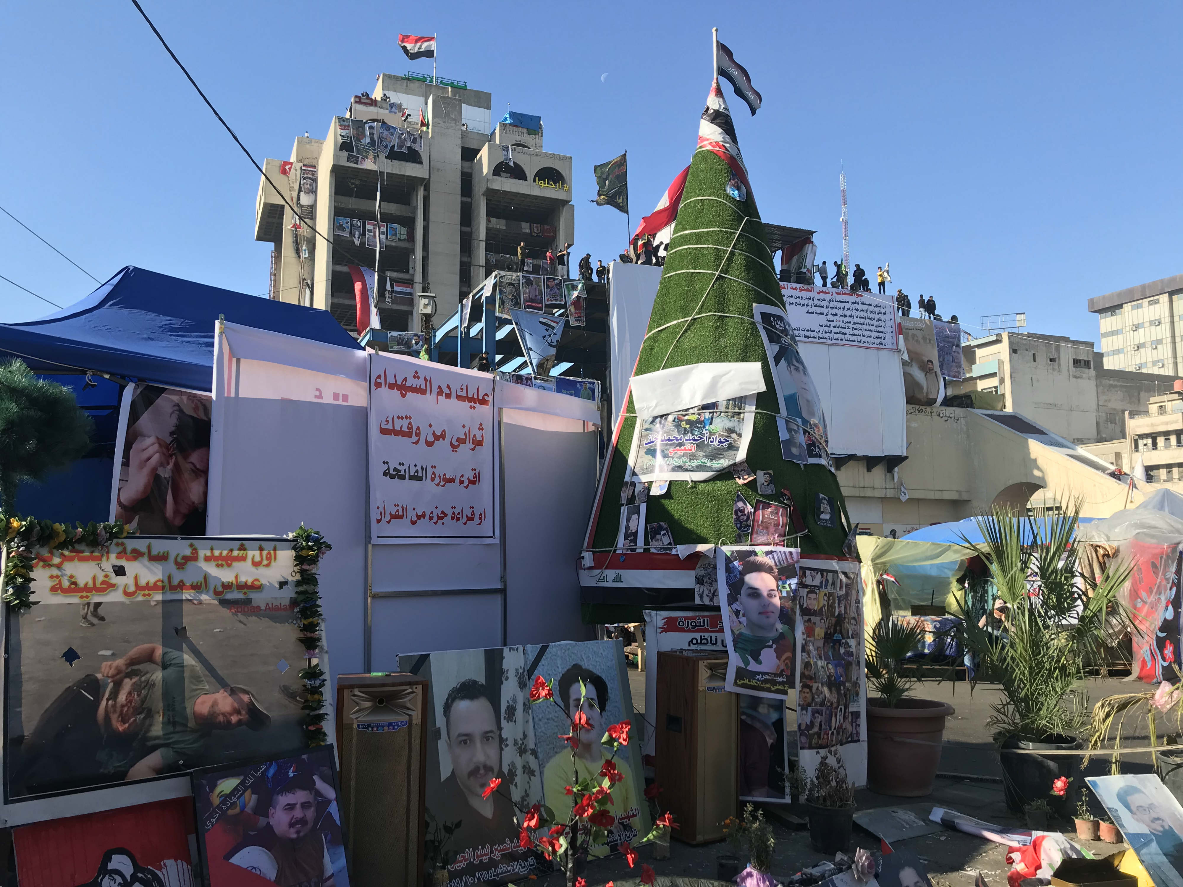 Protesters in Tahrir Square put up pictures of martyrs and decorated them with lights (MEE/Azhar Al-Rubaie)