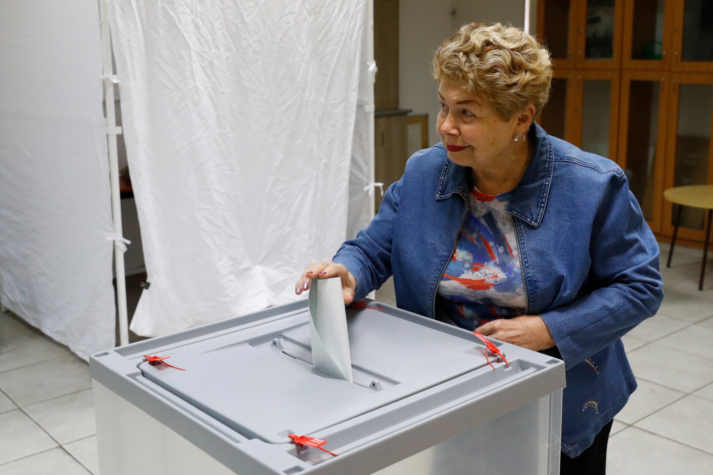 A Russian national residing in Israel casts her vote at a polling station in the coastal city of Netanya, during Russia's 2018 presidential election (AFP)