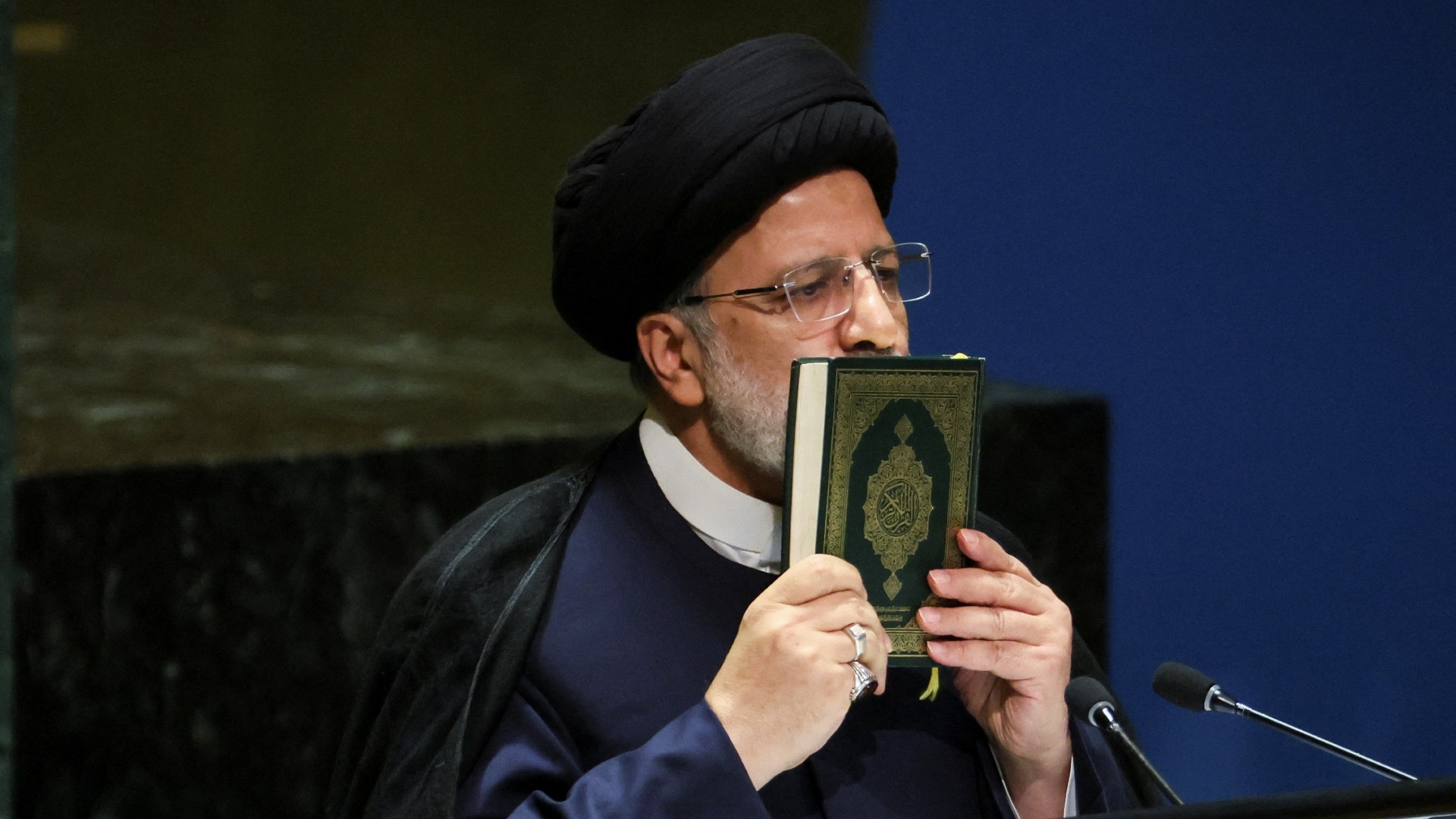 Iran's President Ebrahim Raisi kisses the Quran as he addresses the UN General Assembly in New York City, 19 September (Reuters)