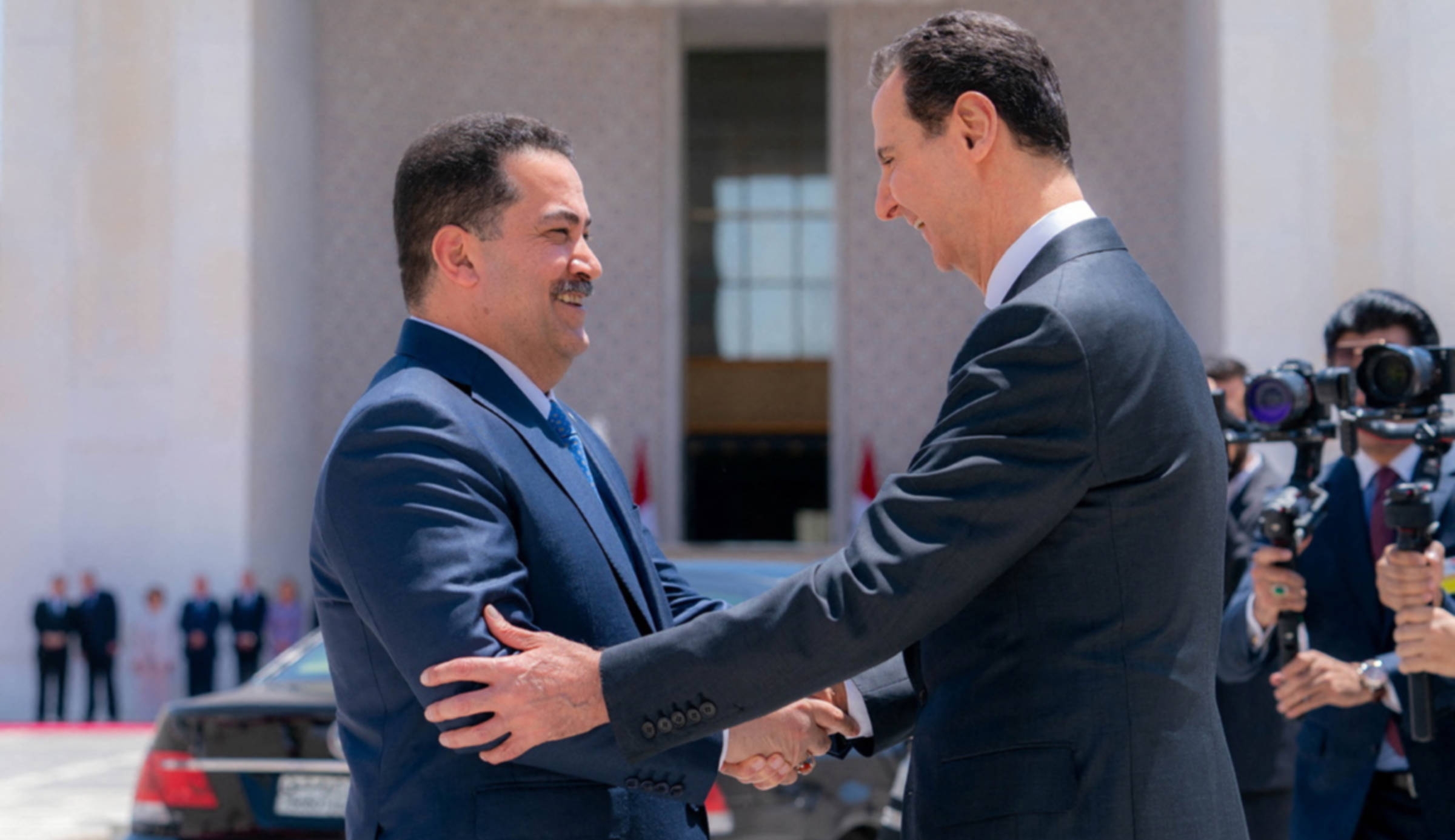 Syria's President Bashar al-Assad greets Iraqi Prime Minister Mohammed Shia Al-Sudani in Damascus, 16 July 2023 (Sana/Reuters)