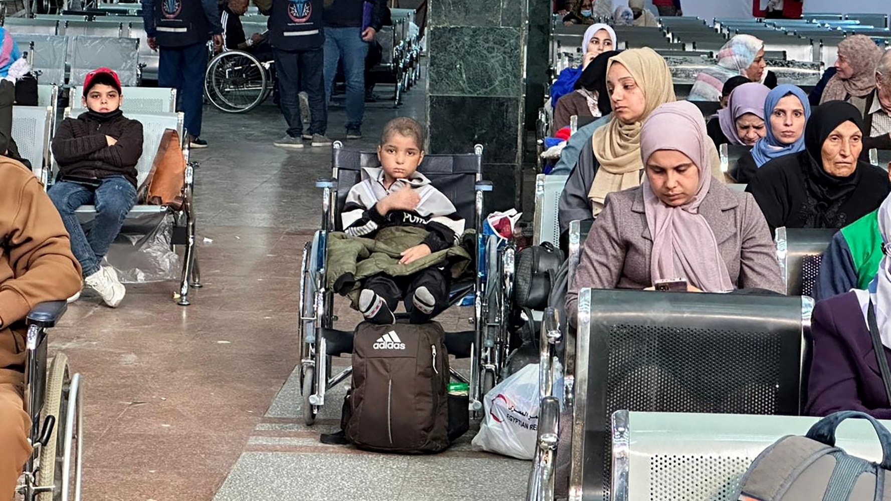 A Palestinian cancer patient waits after crossing into the Egyptian side of the Rafah border crossing in November 2023 (AFP)