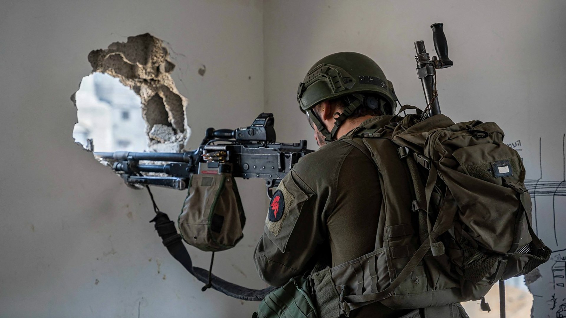 An Israeli soldier aiming his weapon in the Gaza Strip (AFP)