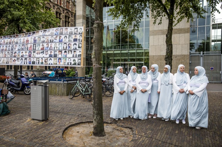 People attend a commemoration of the Srebrenica genocide at The Hague on 11 July (AFP)