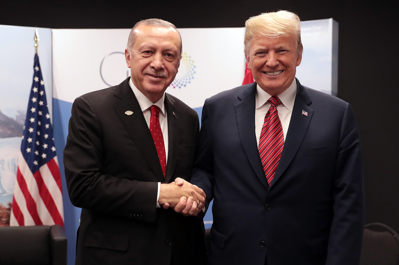 Turkish Presidential Palace Press Office shows Turkey's President Recep Tayyip Erdogan (L) posing with US President Donald Trump (AFP)