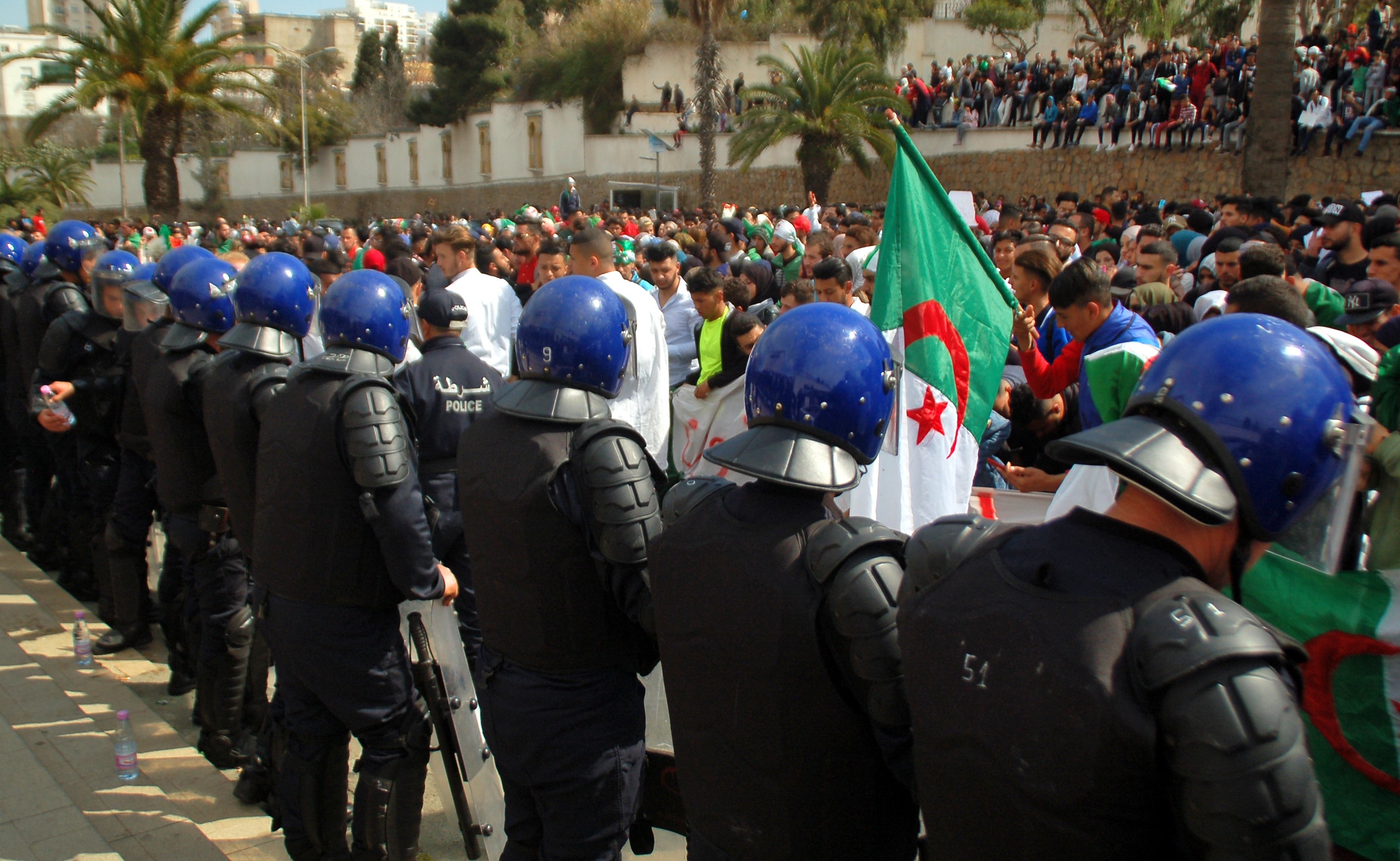 Algerian police stand guard during a protest in Oran on 5 March (AFP)