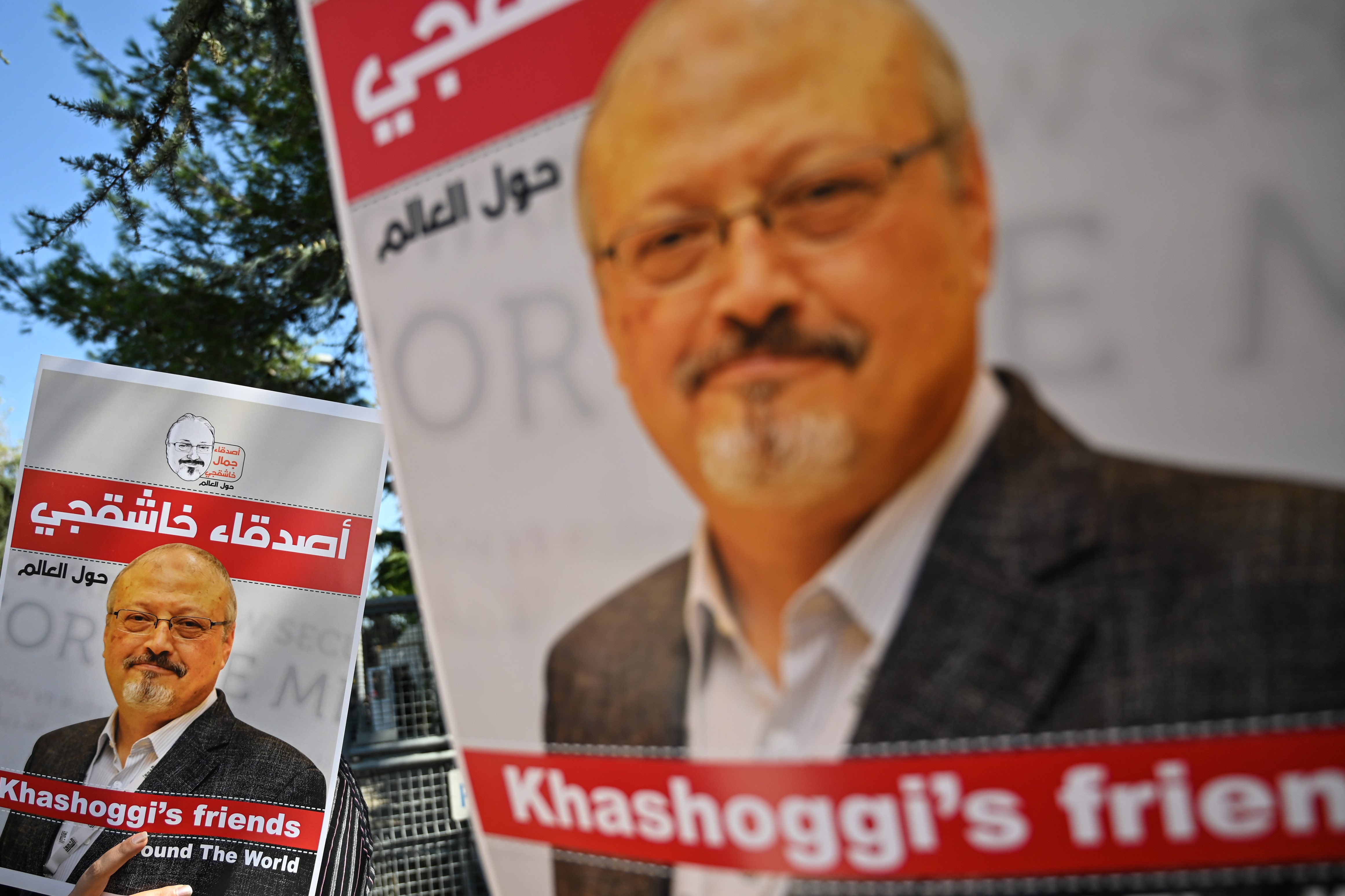 Friends of murdered Saudi journalist Jamal Khashoggi hold posters bearing his picture as they attend an event marking the second-year anniversary of his assassination in front of Saudi Arabia Istanbul Consulate, on October 2, 2020.