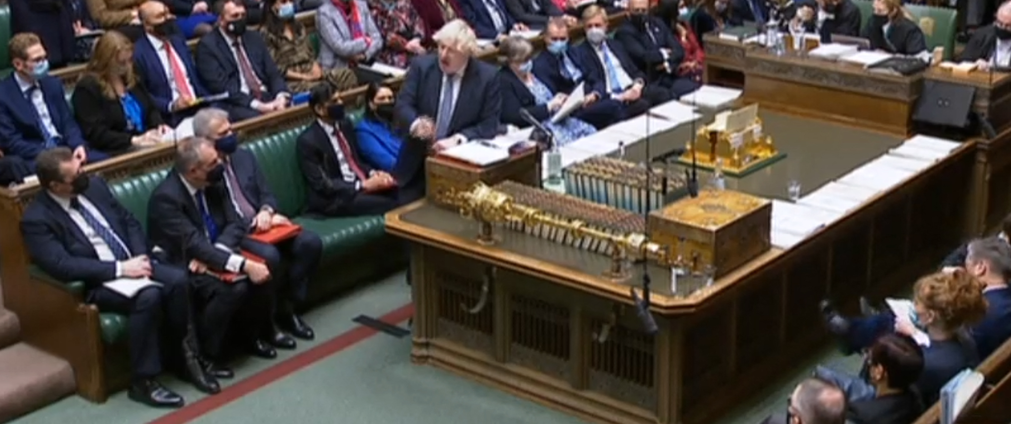 A video grab from footage broadcast by the UK Parliament's Parliamentary Recording Unit (PRU) shows British Prime Minister Boris Johnson speaking during Prime Minister's Questions (PMQs), in the House of Commons in London on December 8, 2021.