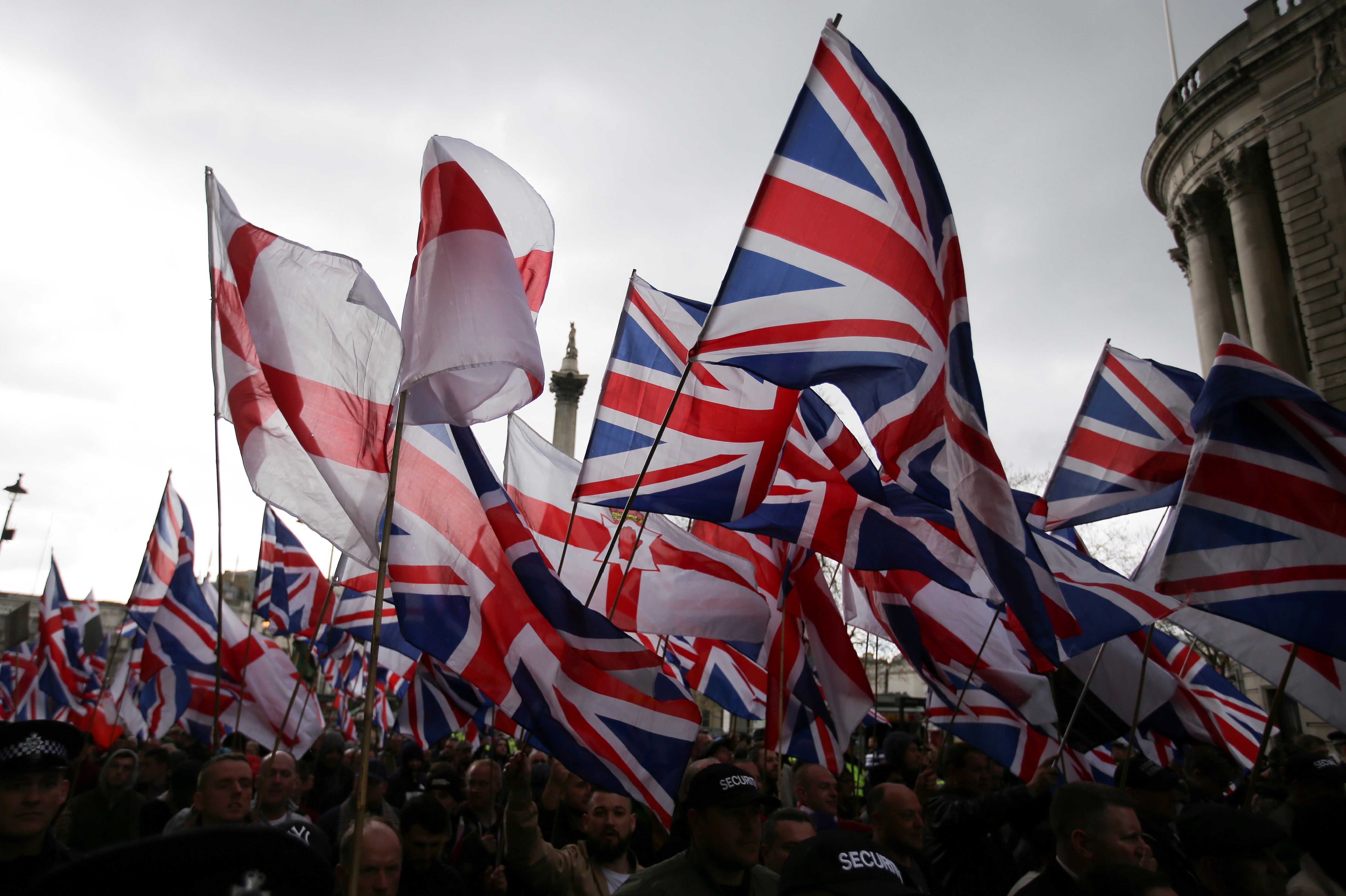 Supporters of the far-right group Britain First wave flags as they march and rally in central London on 1 April, 2017 (AFP) 