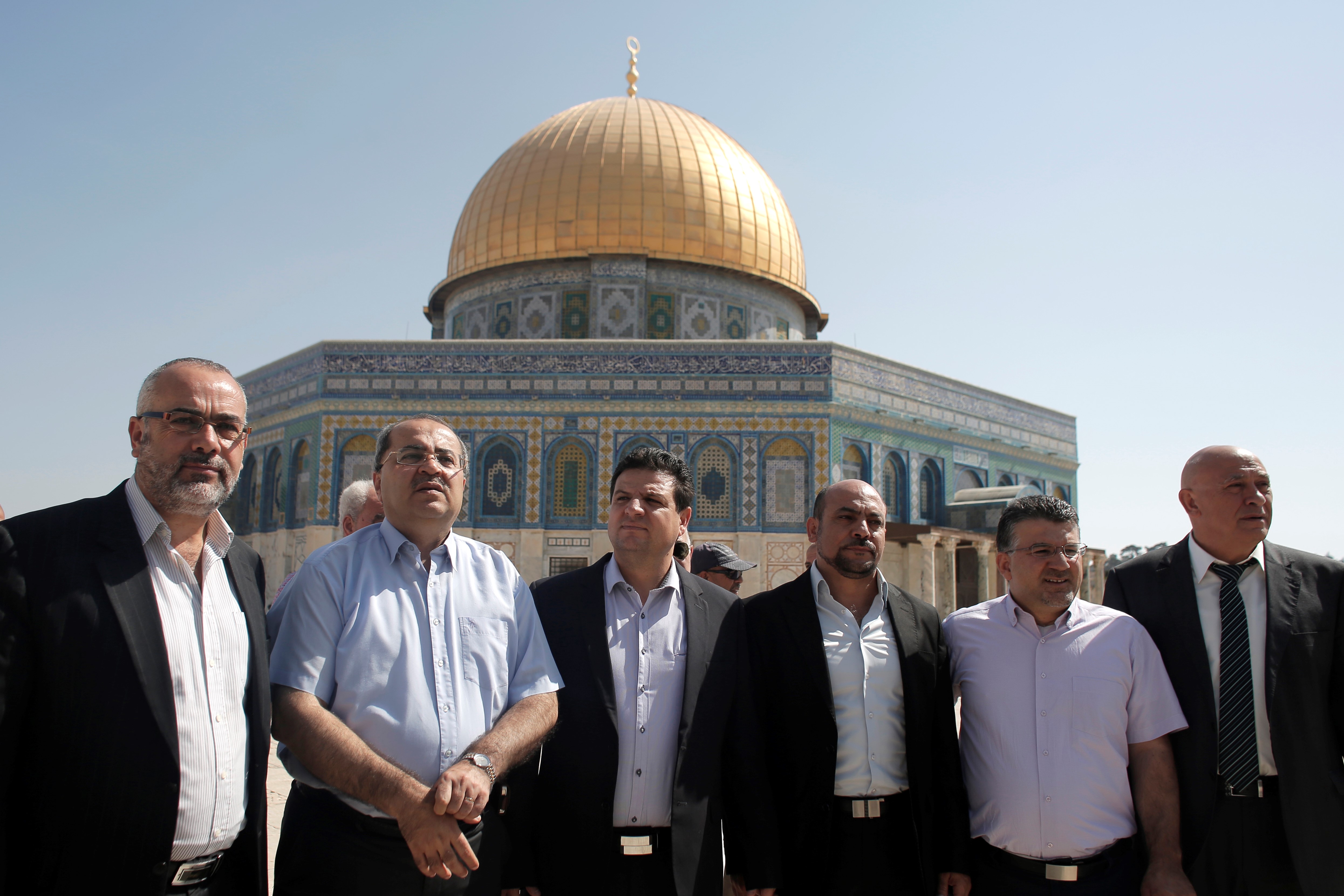 Members of the Joint List of Arab parties pose for a photo in front of the Dome of the Rock at the Al-Aqsa Mosque compound on 28 July, 2015 (AFP)