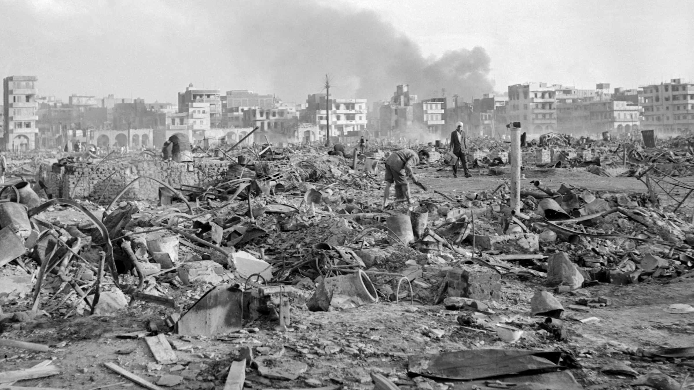Port Said inhabitants search among the ruins of their town following Israel's invasion of Egypt, on 1 November 1956 (Staff/AFP)
