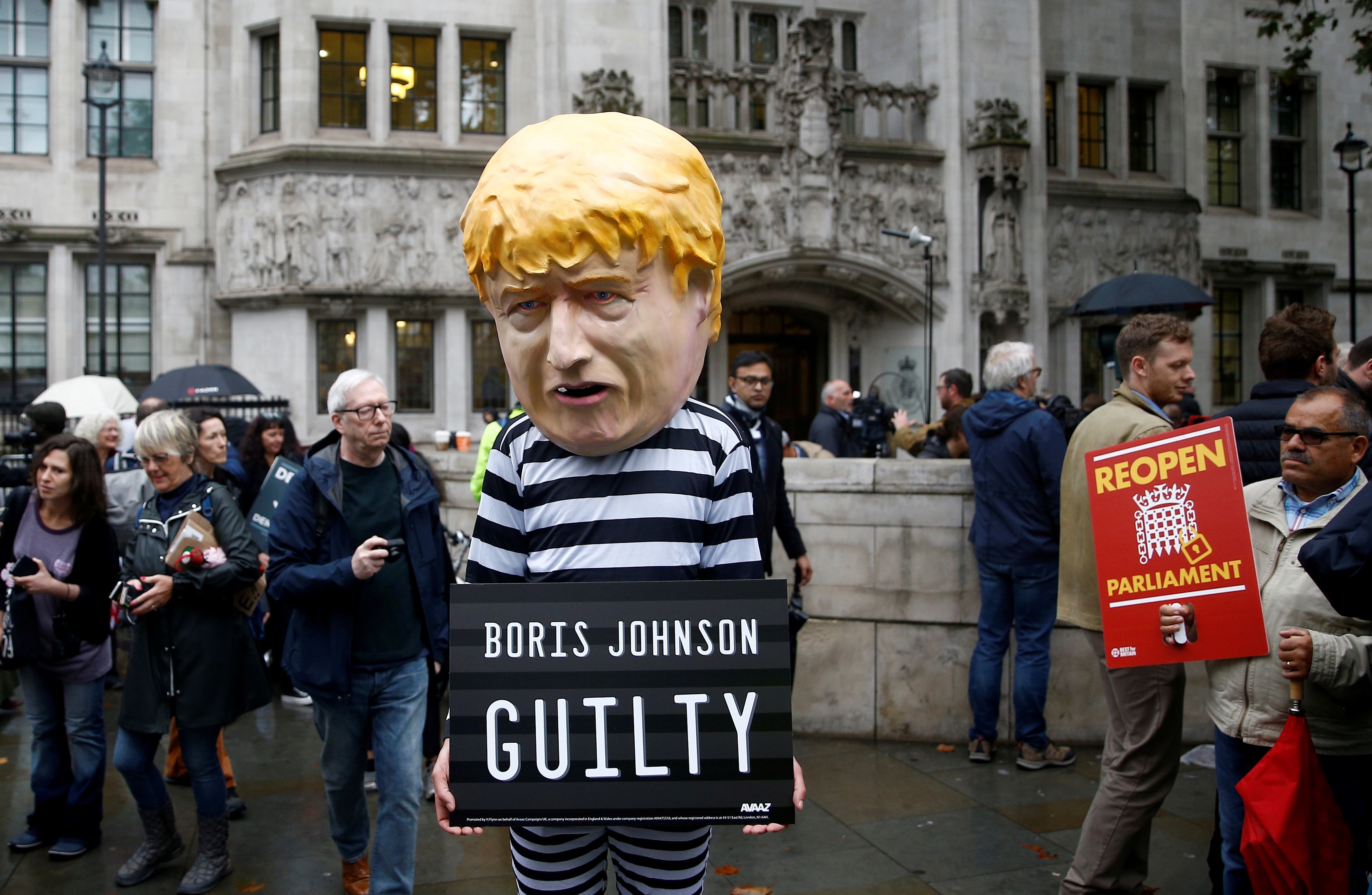  A protester stands outside the Supreme Court of the United Kingdom on 24 September (Reuters)