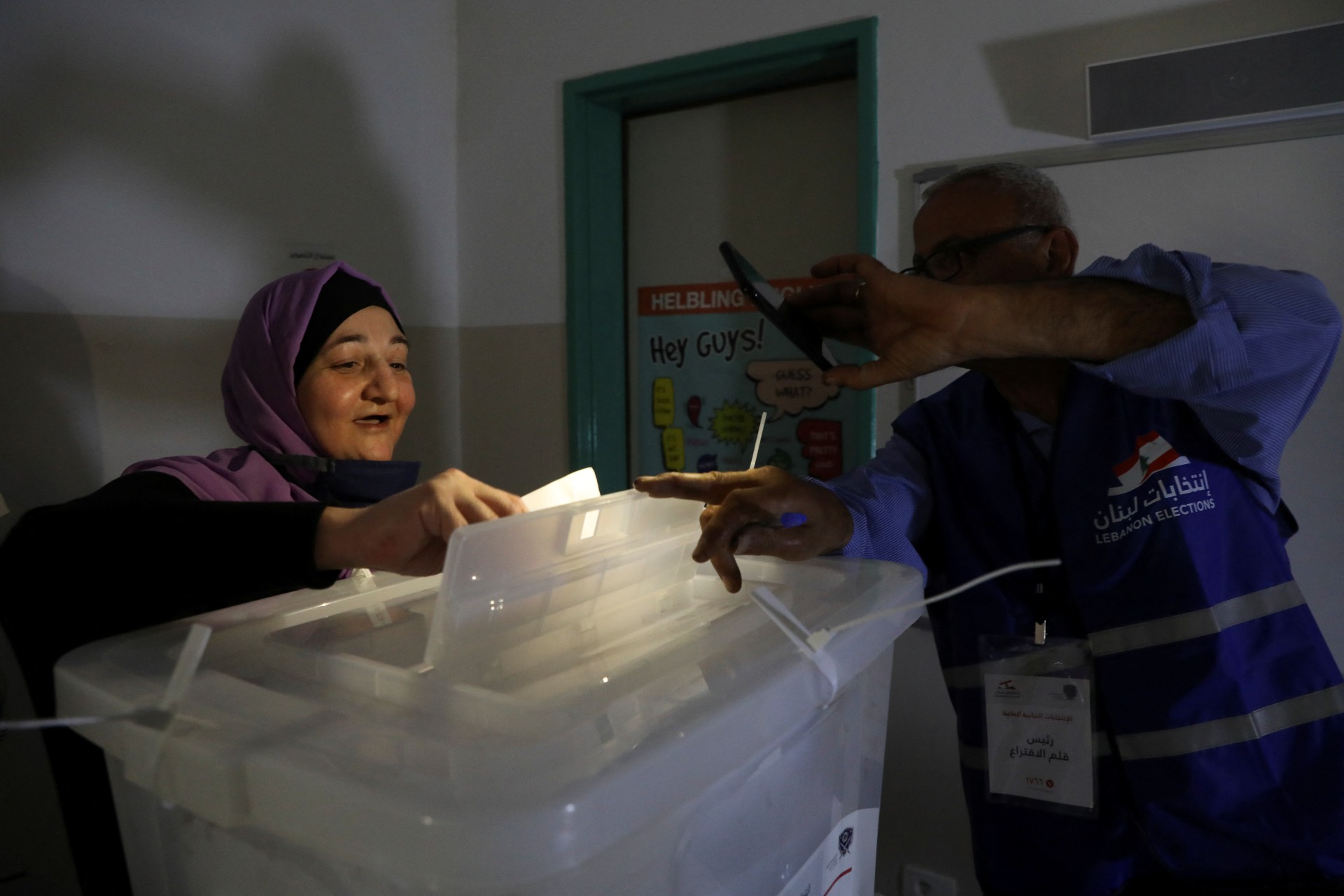 A woman casts her vote at a polling station during a power cut in Lebanon's parliamentary election, in Beirut (Reuters)