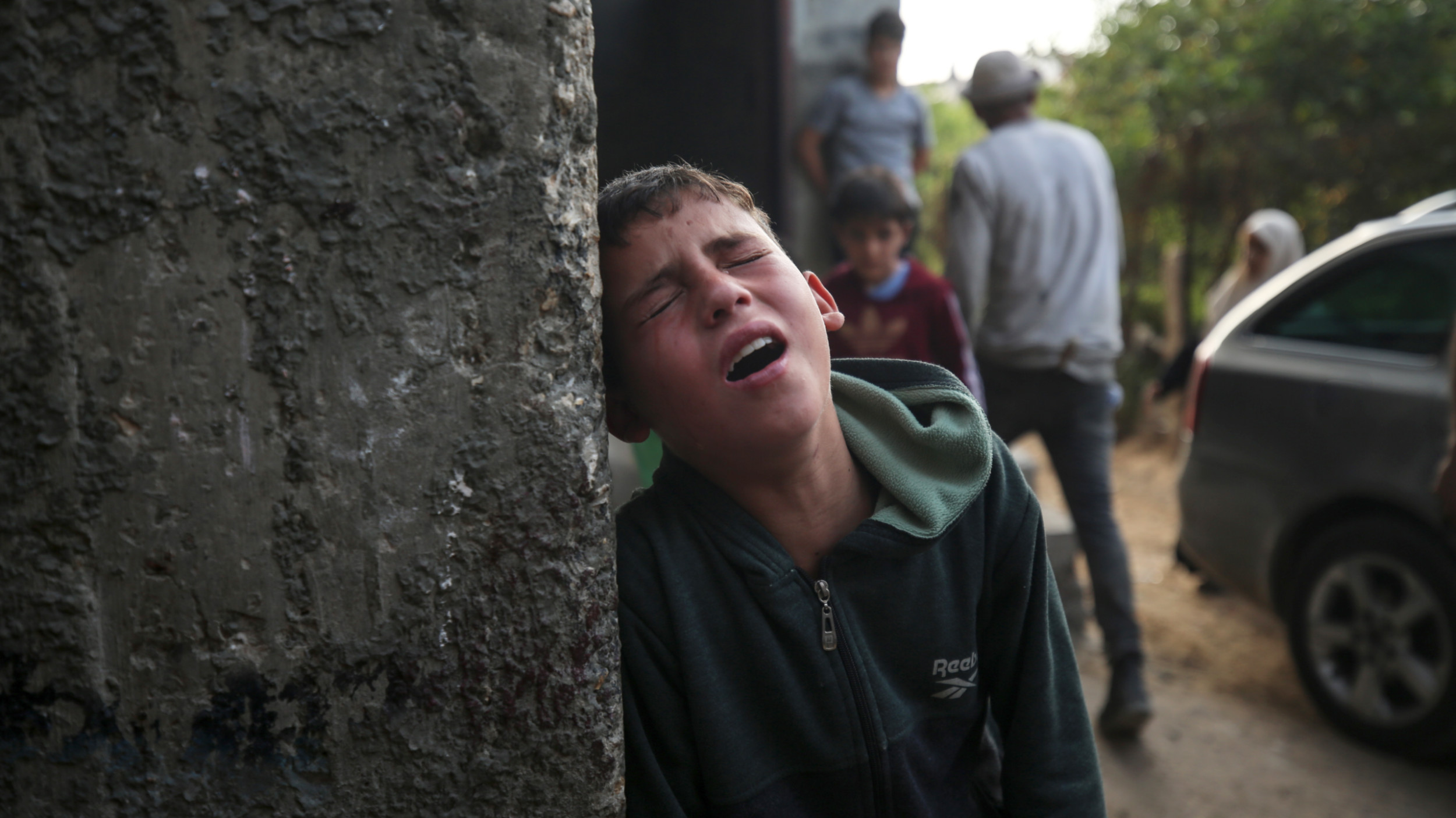 People react following an Israeli air strike in Beit Lahia in the northern Gaza Strip, on 13 May 2023 (NurPhoto via Reuters)