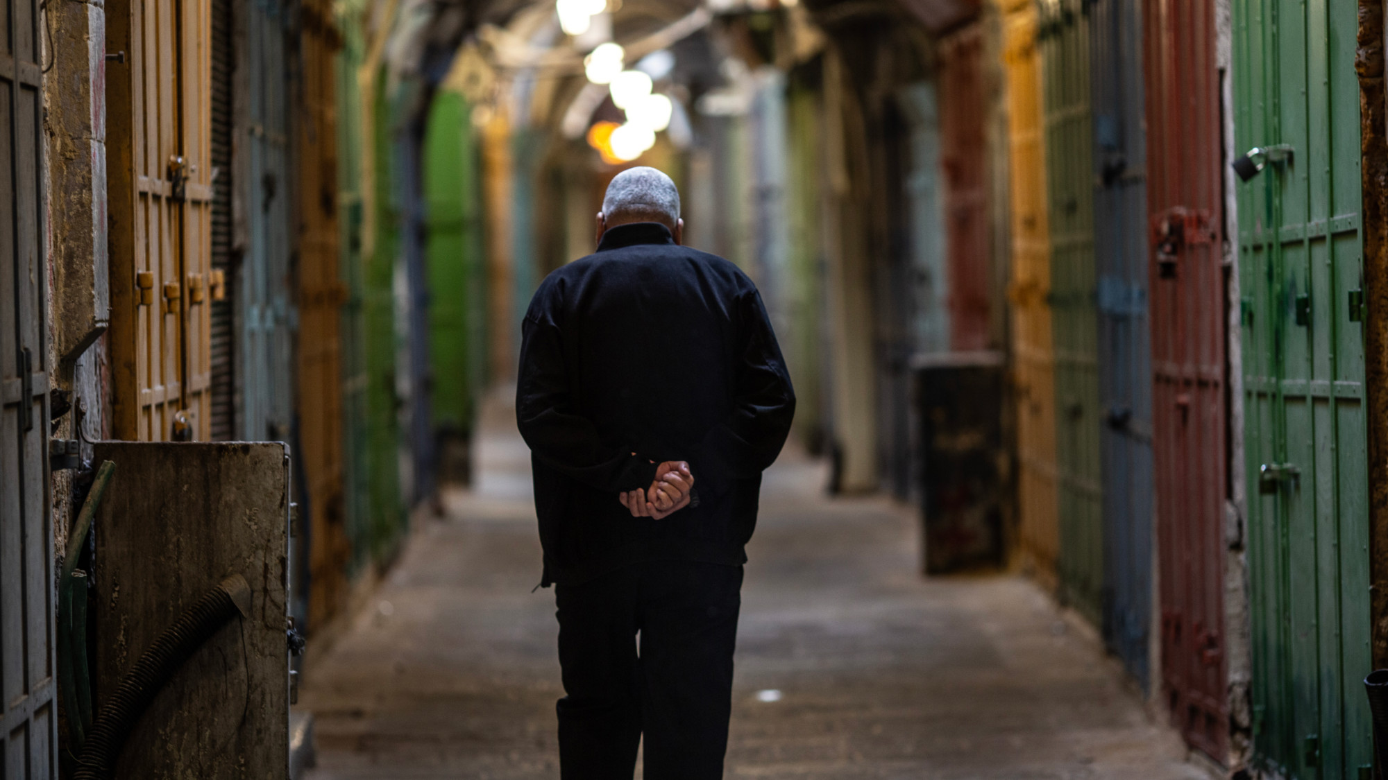 A man walks in Jerusalem's Old City amid a commercial strike observed in the city calling for a ceasefire in Gaza (MEE/Latifeh Abdellatif)