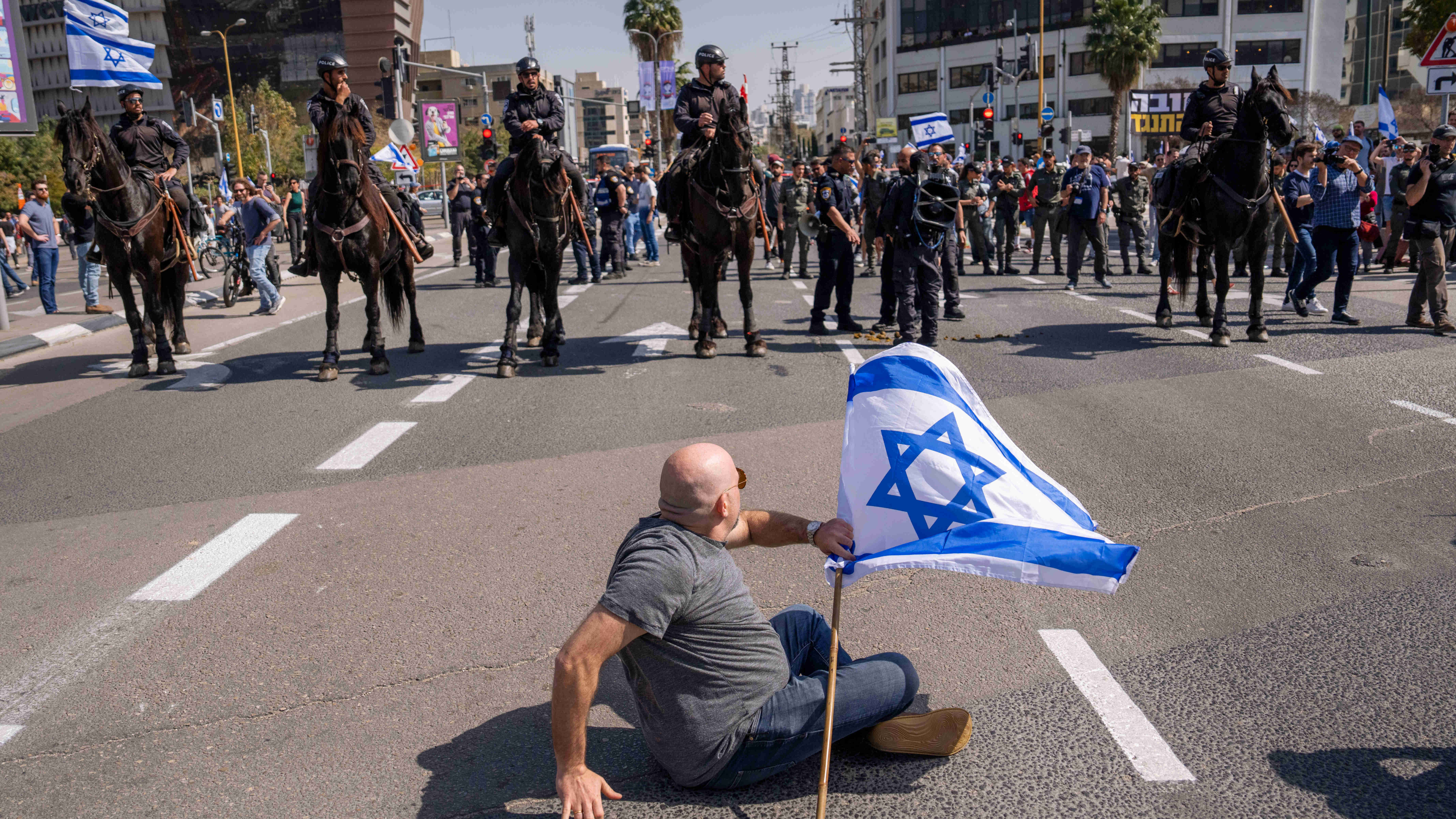Mounted police are deployed as Israelis block a main road to protest the government's judicial overhaul plan in Tel Aviv on a March 2023 (AP)