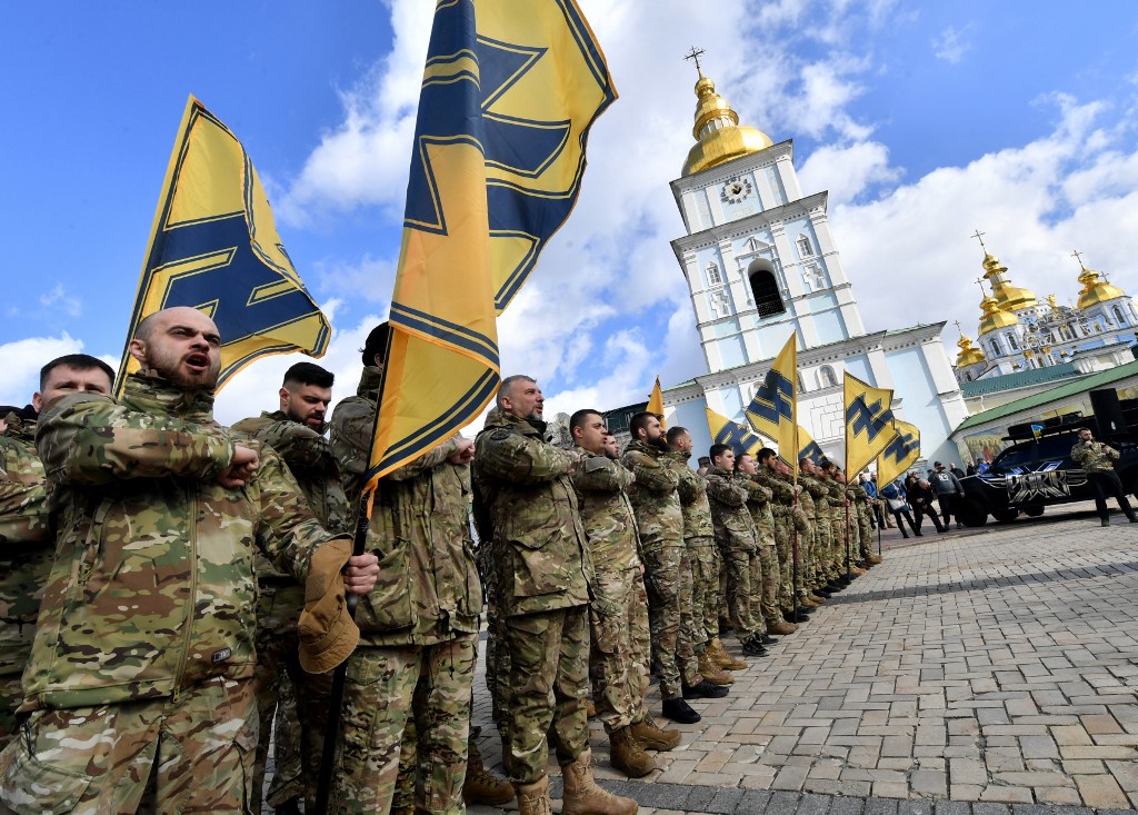 Veterans of the Azov volunteer battalion, who took part in the war with Russia-backed separatists in eastern Ukraine, salute during a mass rally in Kiev on 14 March 2020 (AFP)