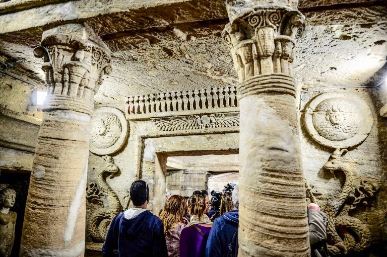 Visitors tour catacombs in Alexandria, Egypt, on Sunday (AFP)