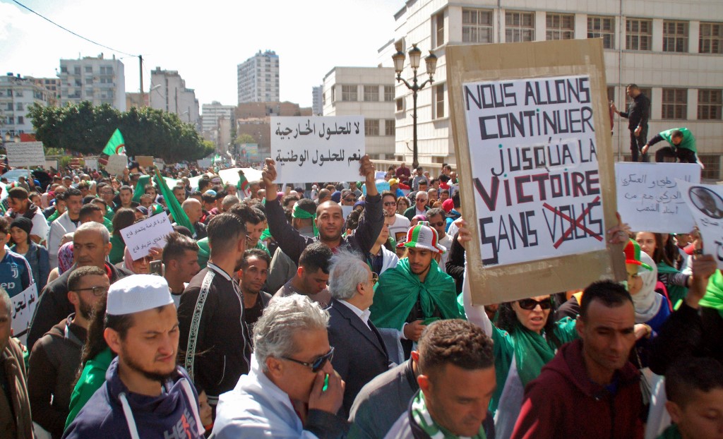 Algerians take part in an anti-government protest in Oran on 9 April (AFP)