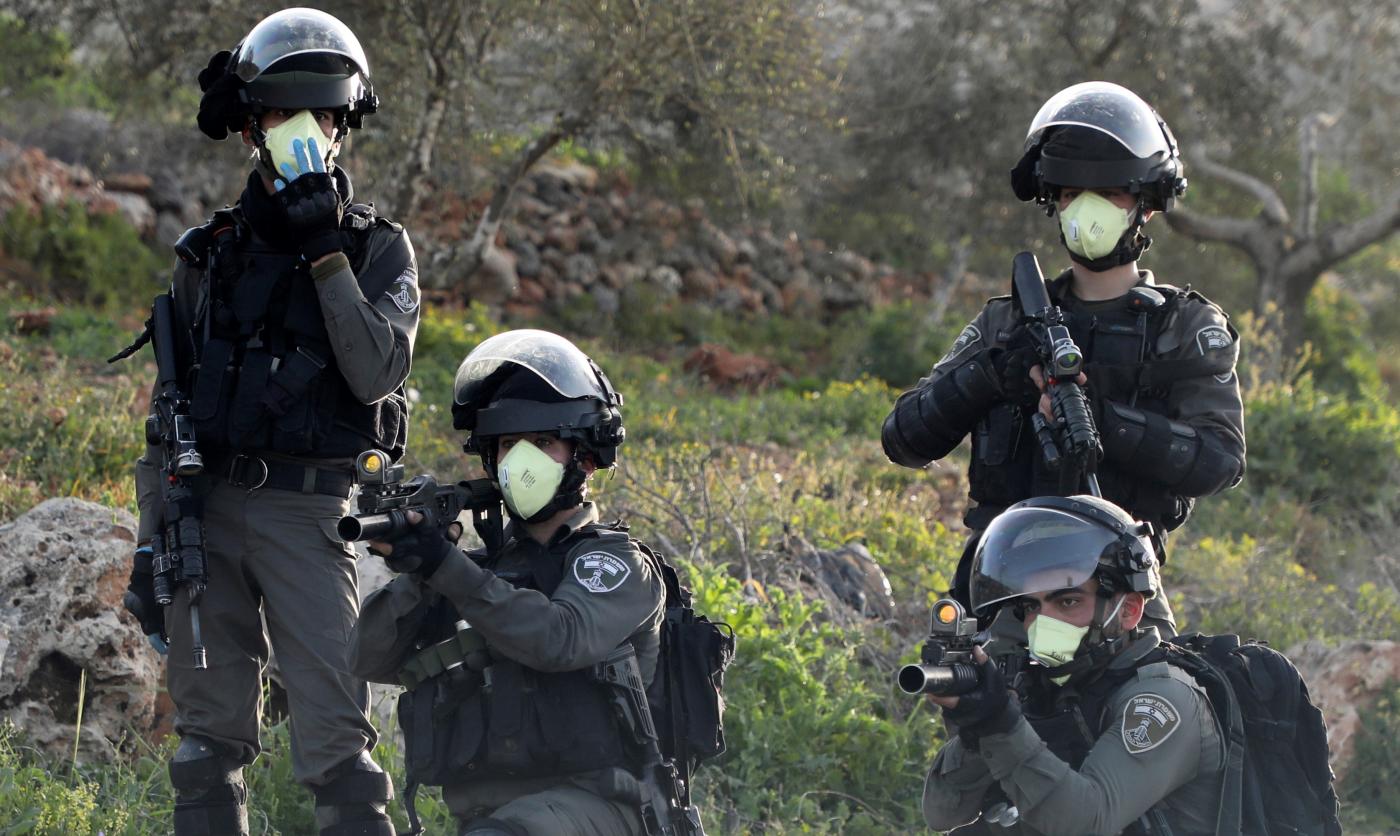 Israeli border guards aim their weapons in the occupied West Bank on 11 March (AFP)