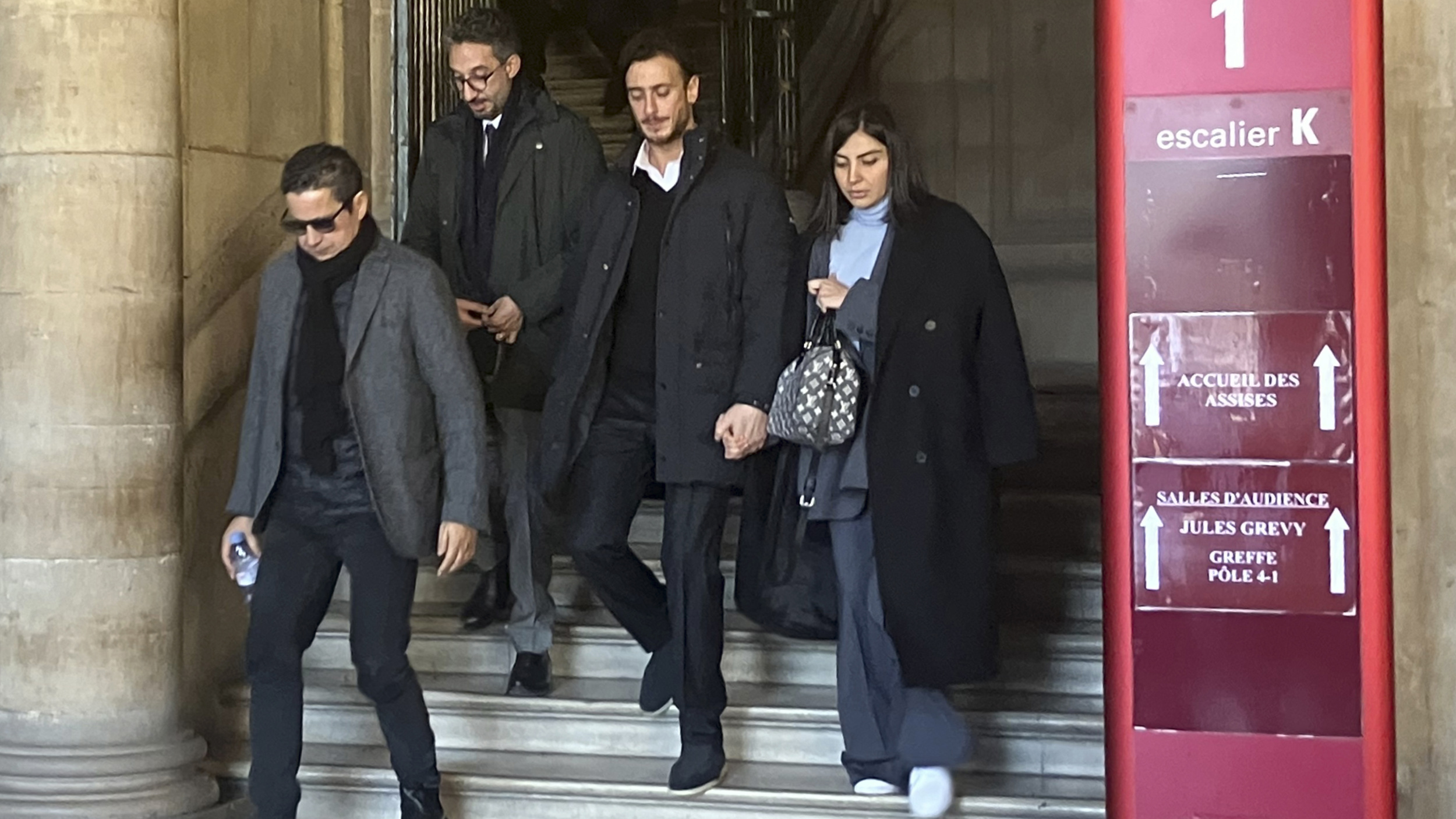 Moroccan singer Saad Lamjarred, second right, leaves court in Paris on 20 February 2023 (AP)