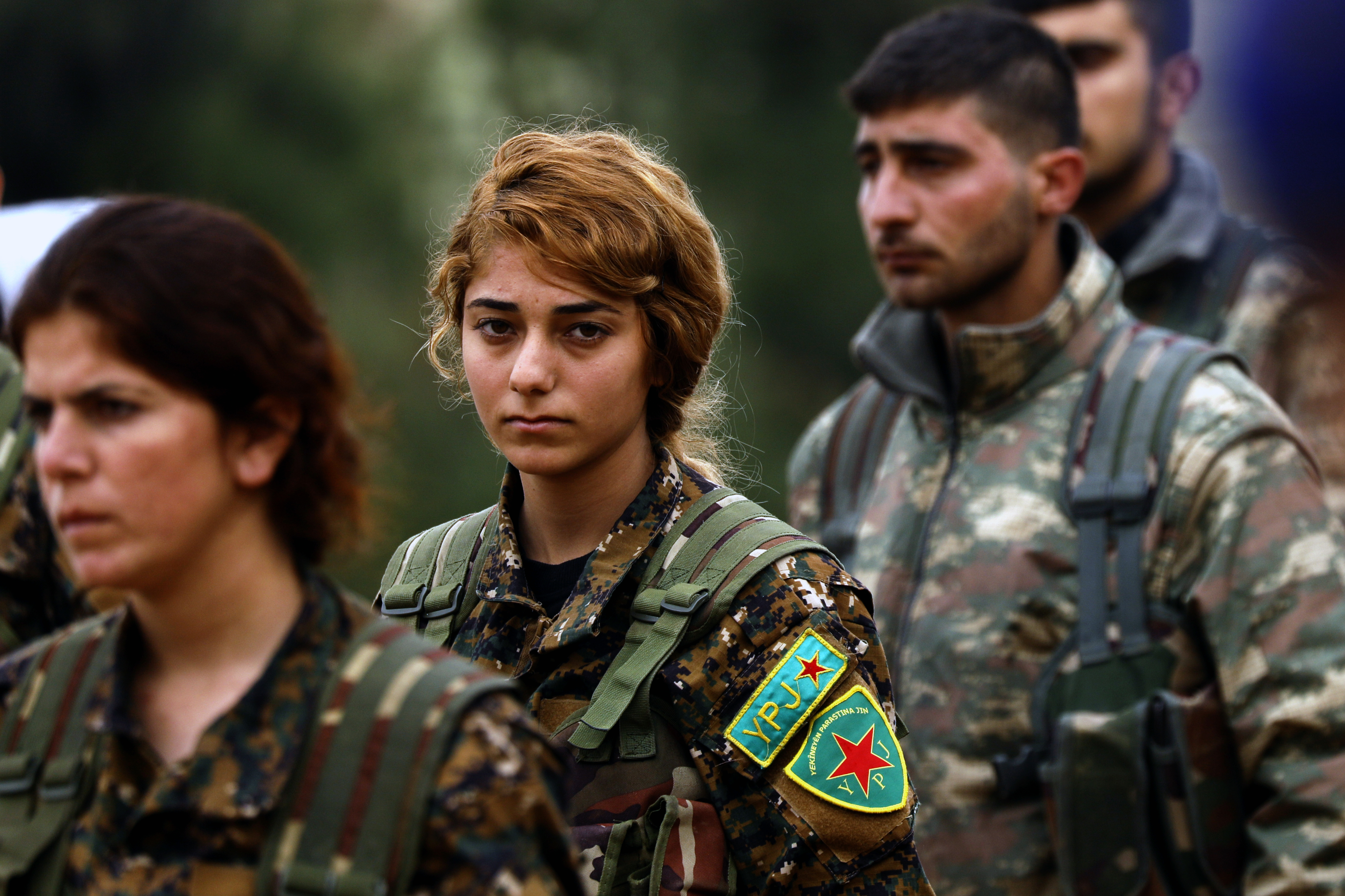 Fighters from the Kurdish women's protection units (YPJ) attend the funeral of a fellow fighter, who was killed while fighting against the Islamic State (IS), in northeastern Syrian Kurdish-majority city of Qamishli (AFP)