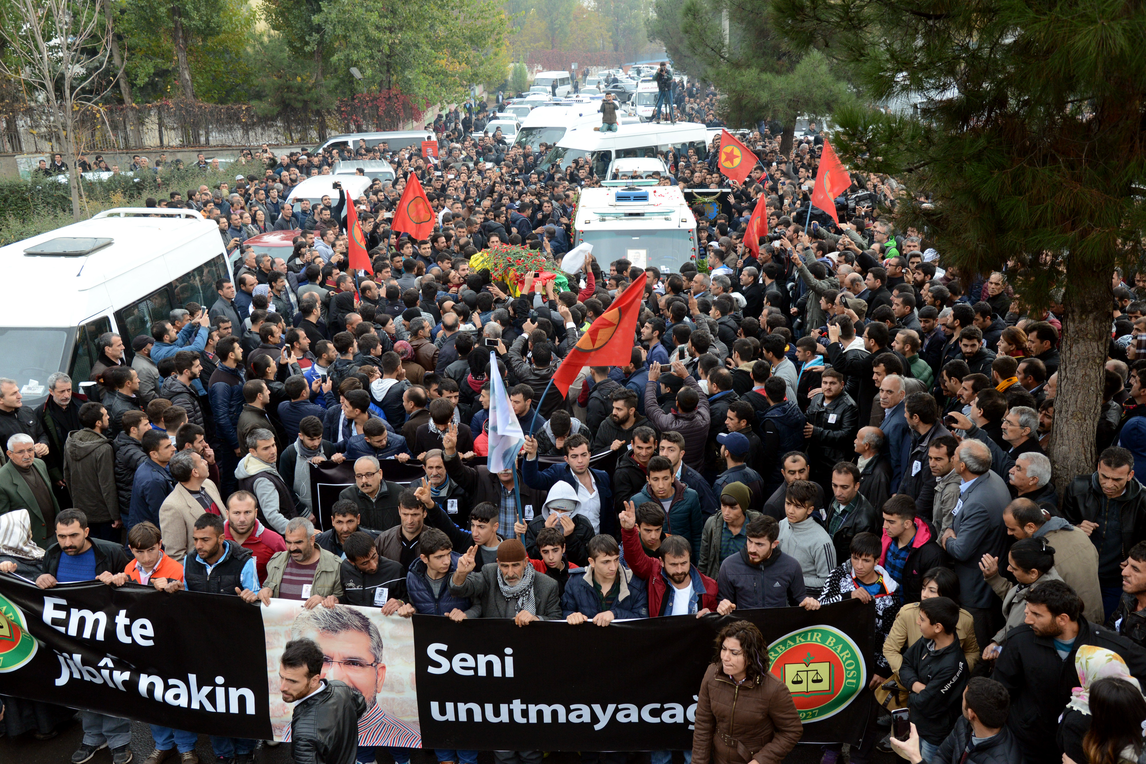 People carry the coffin of killed Kurdish Lawyer Tahir Elci during his funeral the day after his assassination in Diyarbakir (AFP)