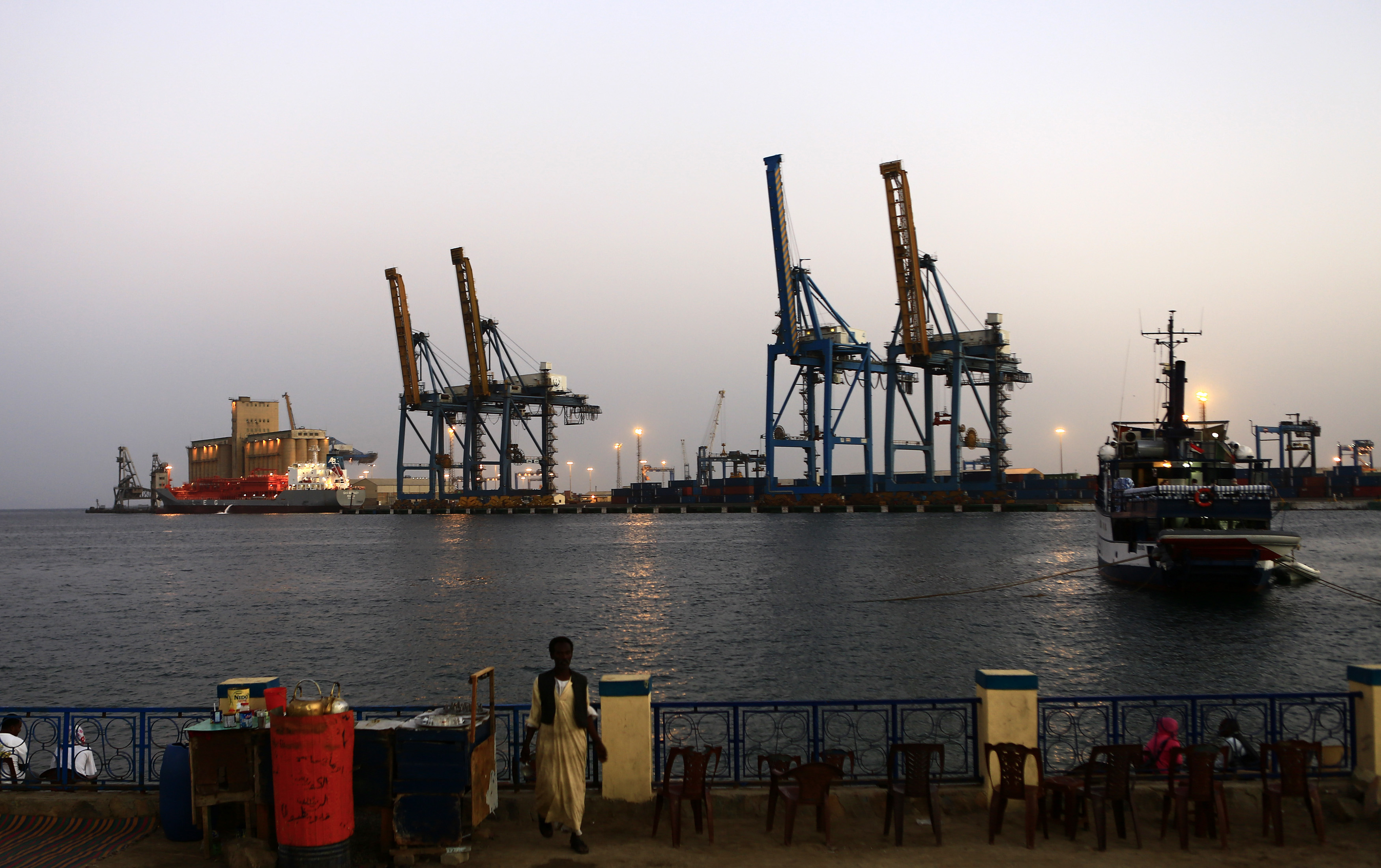 A man stands opposite the modern port at the harbour in Port Sudan (Reuters)