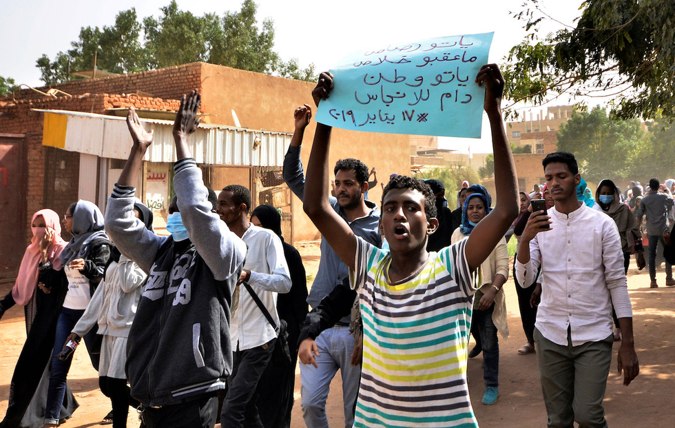 Protesters march towards presidential palace in Khartoum on Thursday (Reuters)