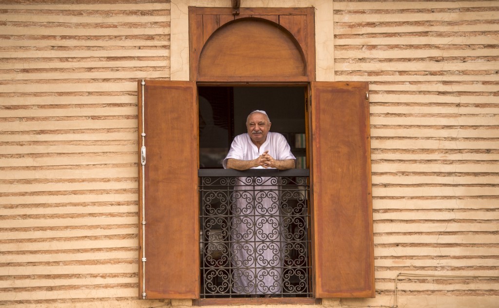 A Moroccan Jewish man looks out his window at the street below from his house in the "Mellah" Jewish quarter of the Medina in Marrakesh, on October 13, 2017.