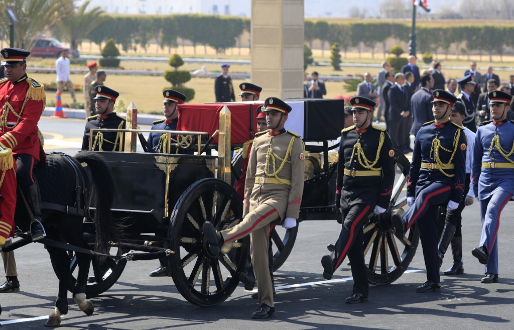 Egyptian honour guards escort Mubarak’s coffin during his funeral ceremony in Cairo on 26 February (AFP)