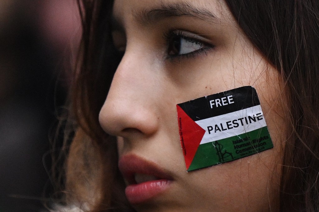 A protester holds a placard while taking part in the "Day of Action for Palestine” from Chalk Farm to Camden Town, in London, on 18 November 2023 calling for a ceasefire in the Gaza war (AFP)