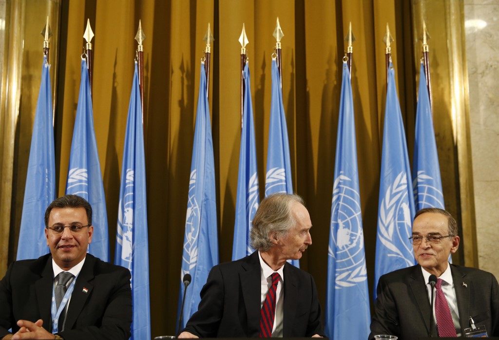 The UN special envoy to Syria, Geir Pedersen, centre; Syrian MP Ahmad al-Kuzbari, left; and opposition representative Hadi al-Bahra attend the committee opening in Geneva on 30 October (AFP)
