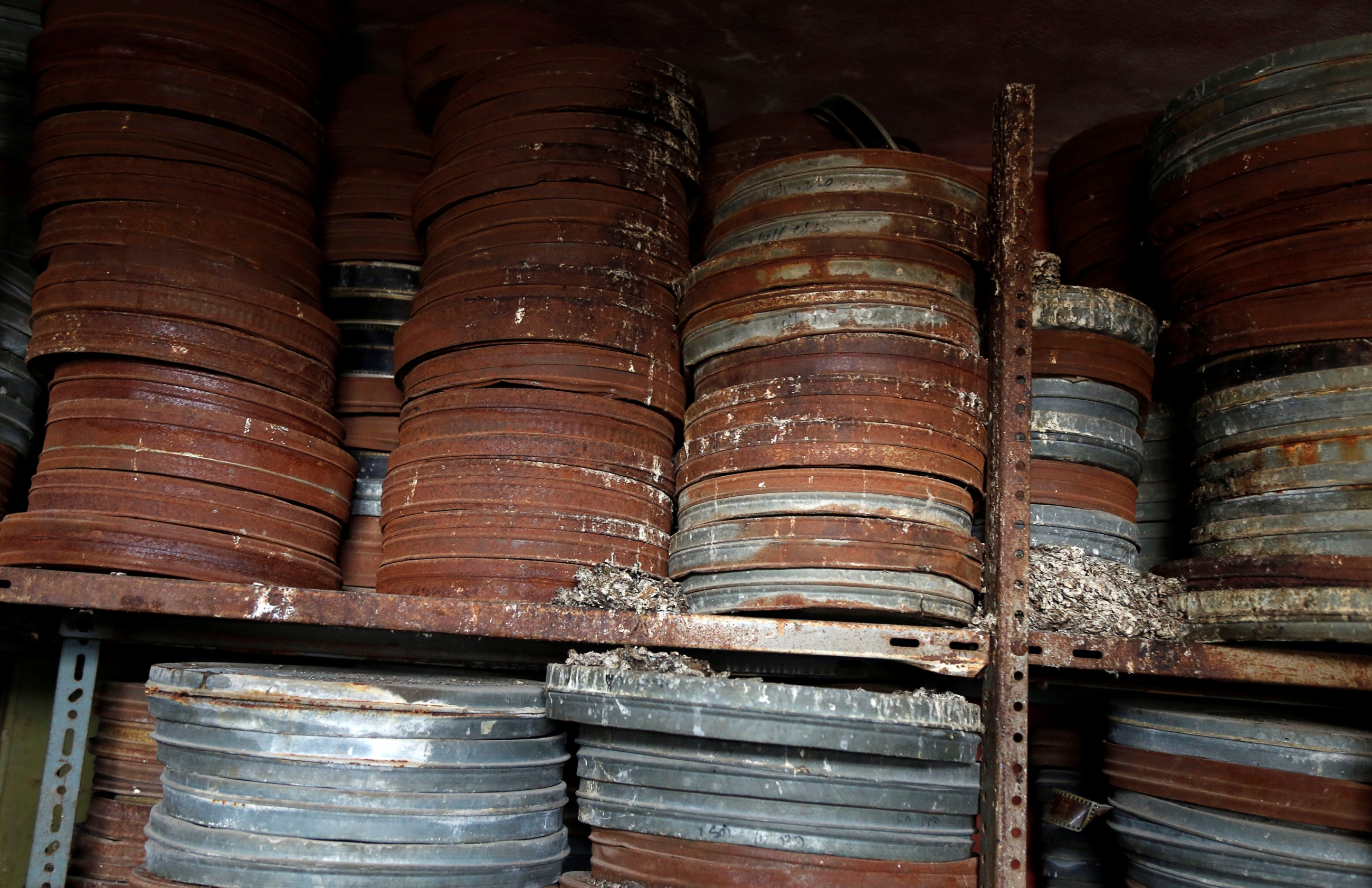Shelf upon shelf of rusting and corroded film canisters pack the upper floors of the wedding hall: many have not been unsealed for decades. (Reuters)