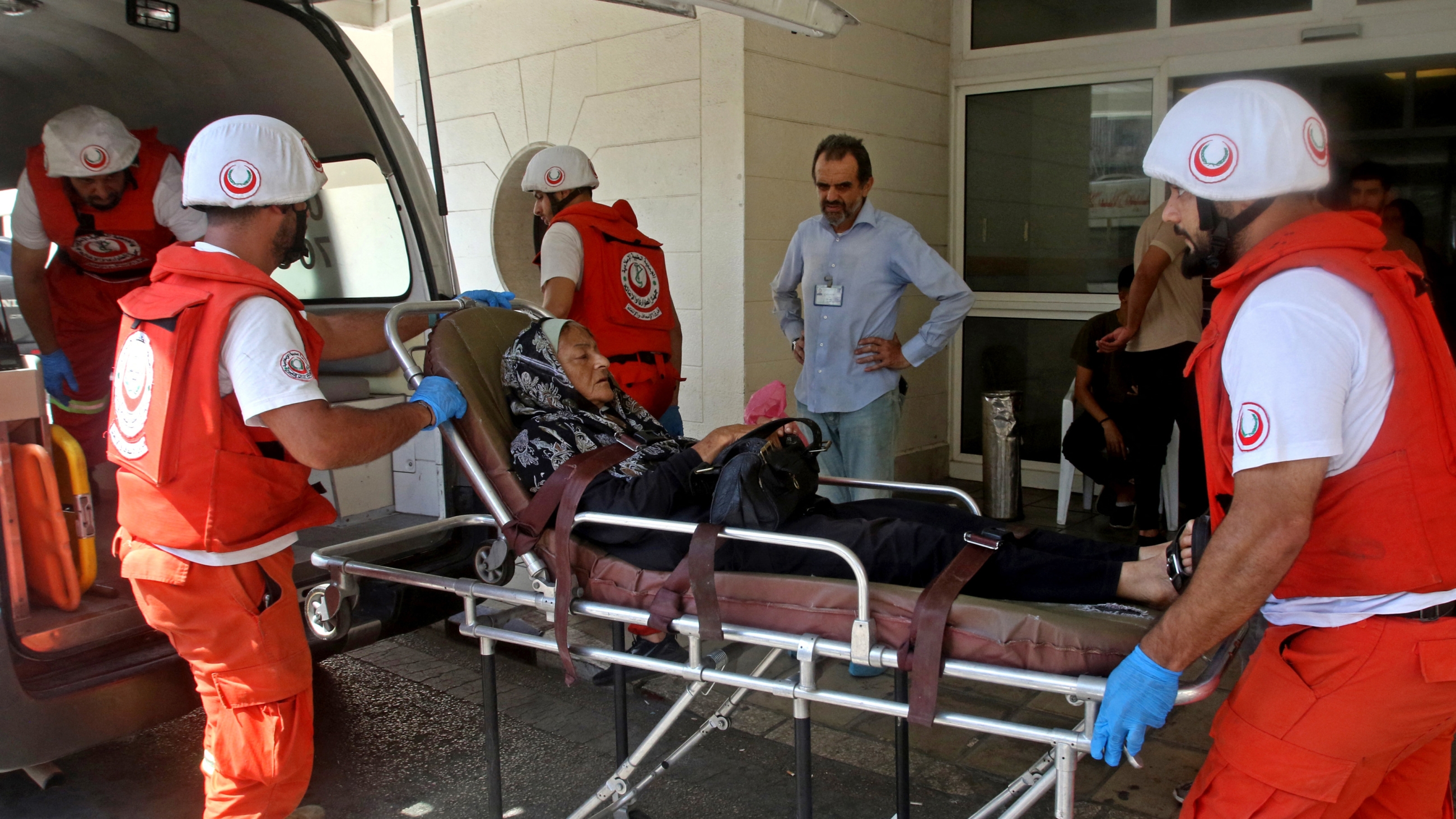 Paramedics evacuate injured woman from a government hospital in Sidon on 9 September 2023 following renewed clashes at Ain al-Hilweh Palestinian refugee camp (AFP)