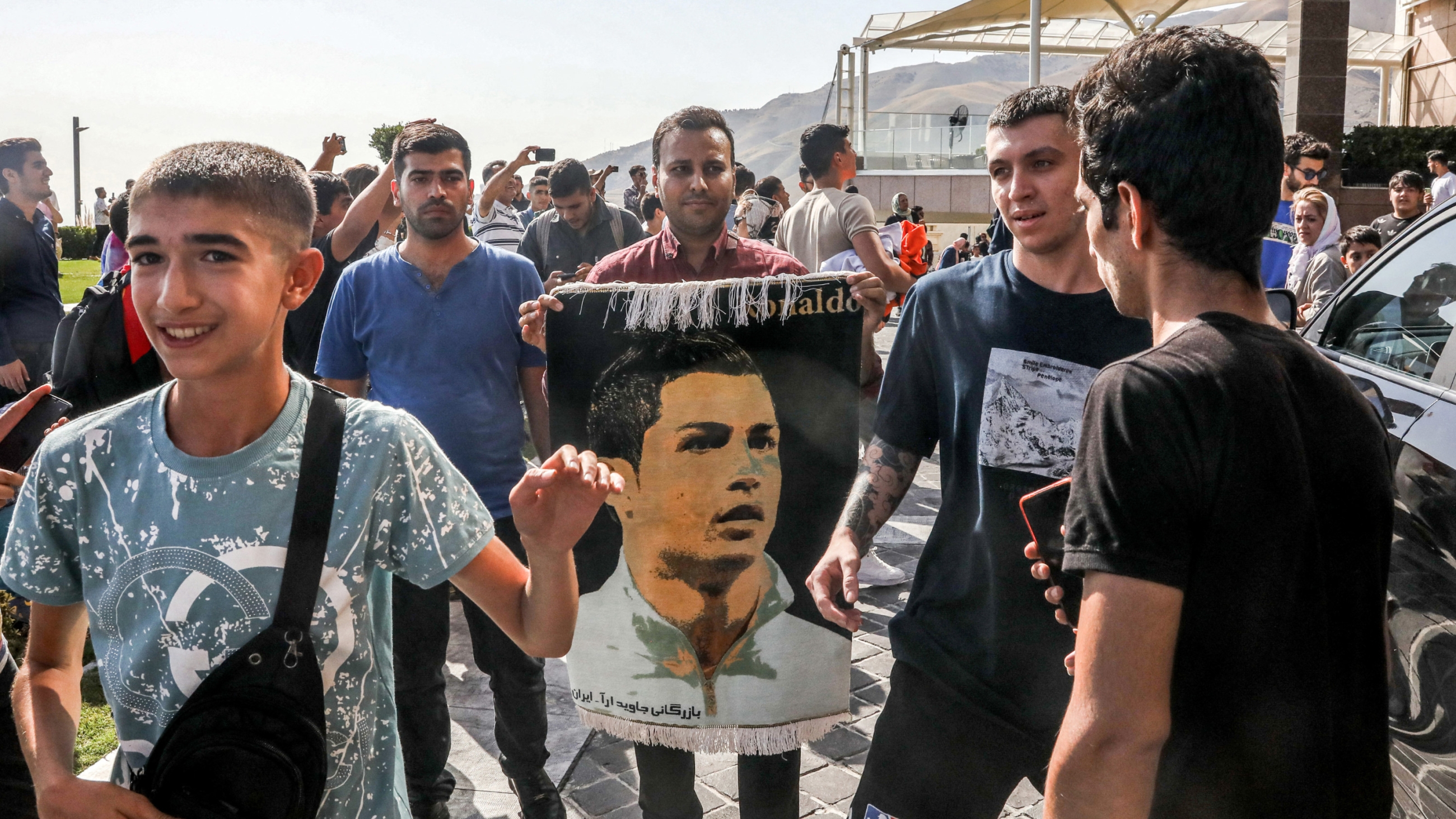 Fans of Saudi football club al-Nassr's Portuguese forward Cristiano Ronaldo gather outside the team's hotel in Tehran on 18 September 2023 (AFP) 