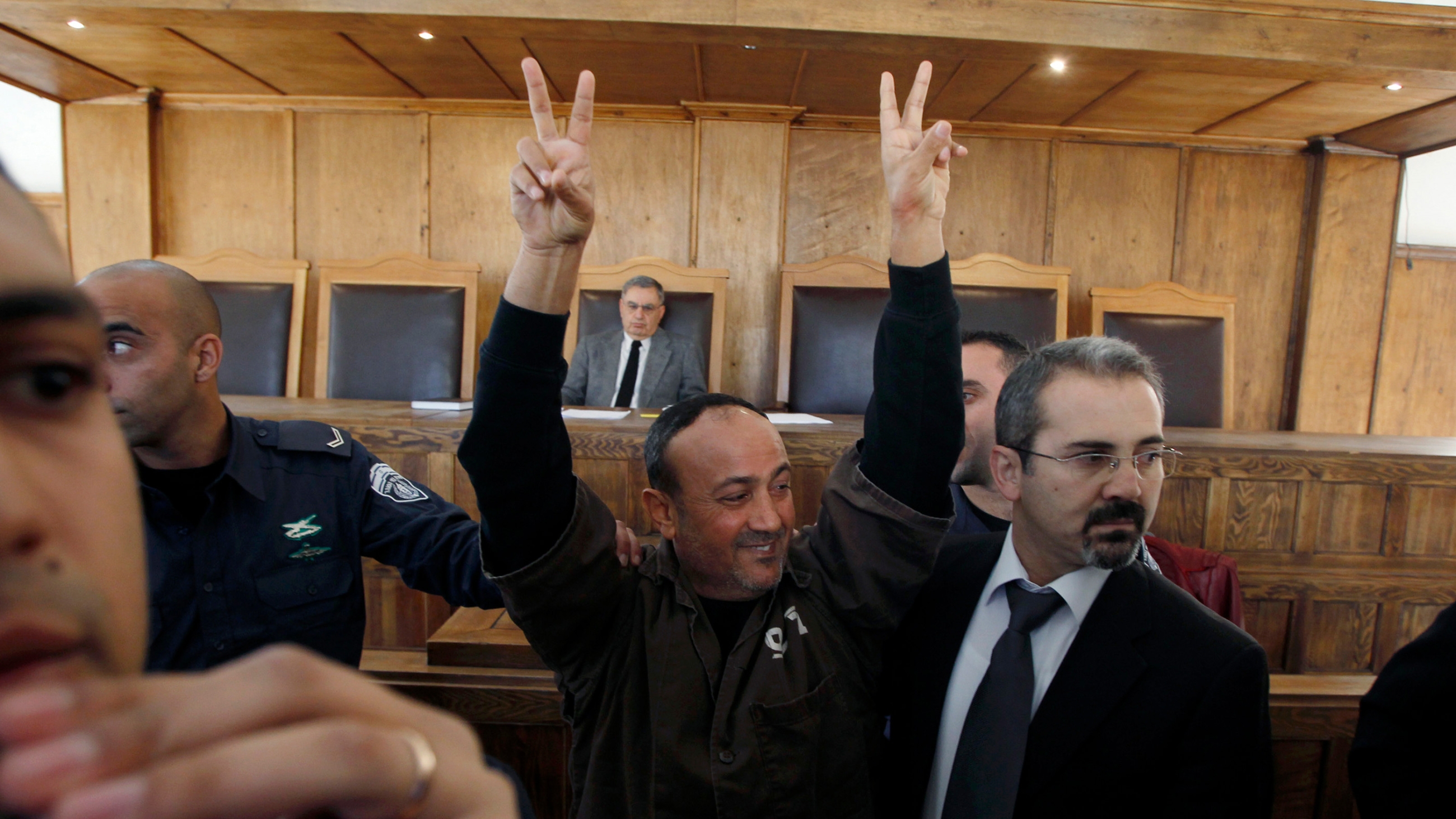 Jailed Fatah leader Marwan Barghouti (C) gestures before the start of a deliberation at Jerusalem Magistrate's court 25 January 2012 (Reuters)