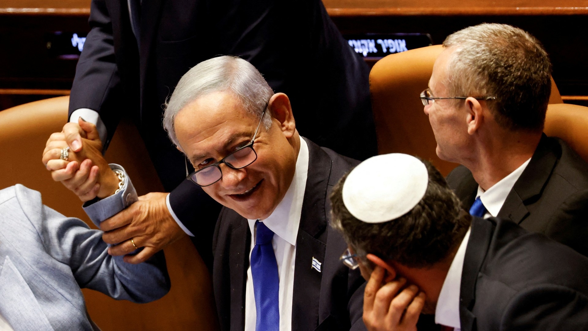 Israeli Prime Minister Benjamin Netanyahu and lawmakers gather at the Knesset plenum to vote on a bill to limit some Supreme Court power, in Jerusalem 24 July (Reuters)