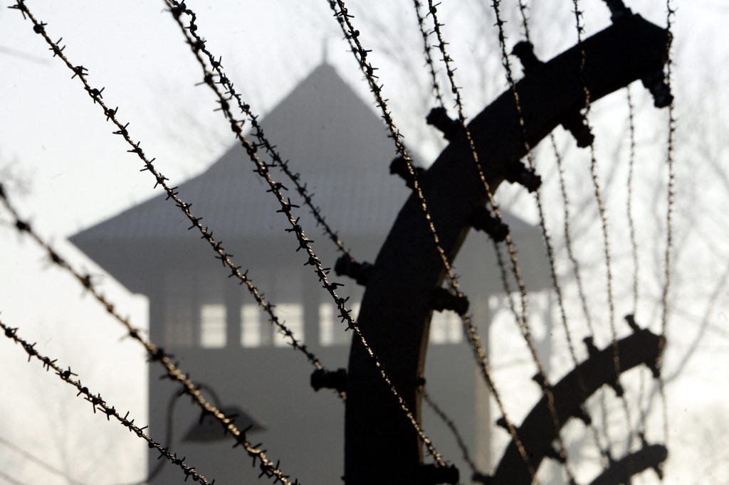 A barbed wire fence and watch tower at Auschwitz concentration camp, 12 January 2005 (AFP)