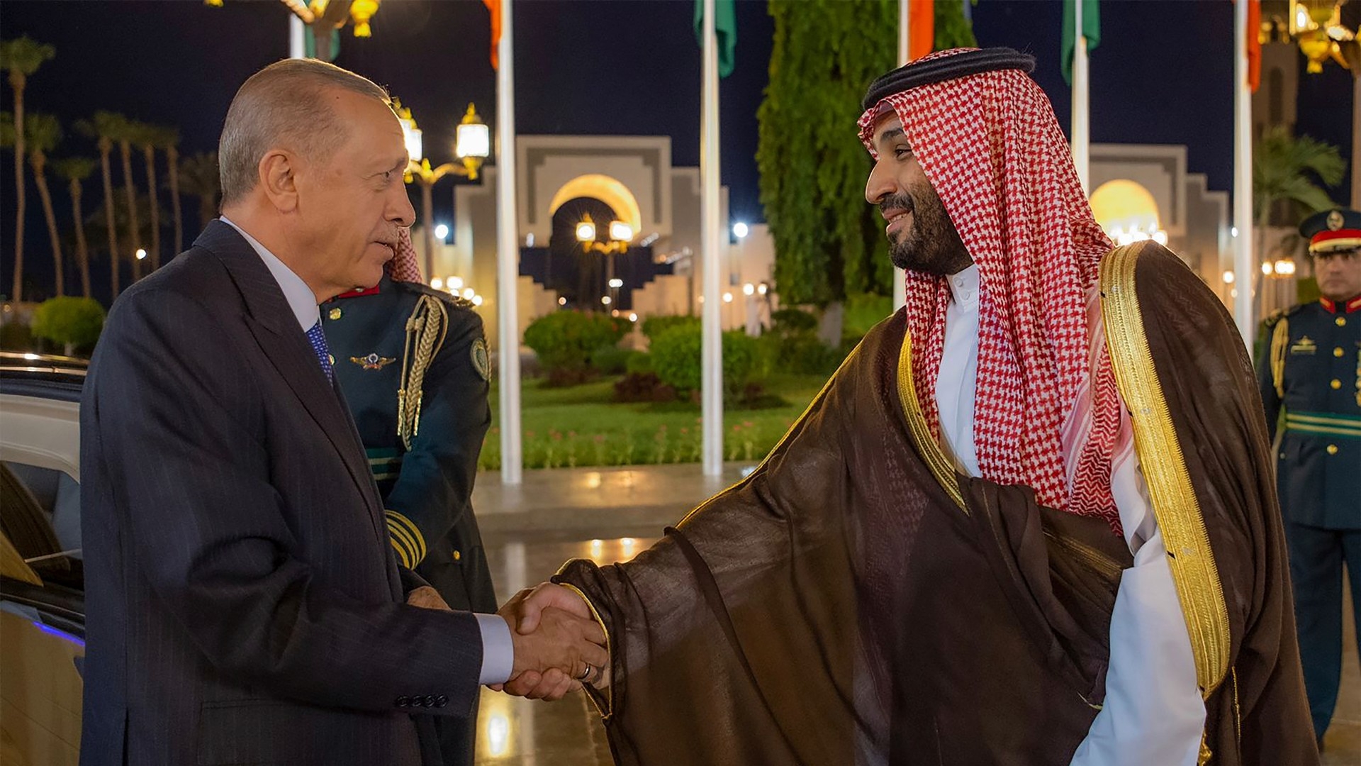 Turkish President Recep Tayyip Erdogan, left, and Saudi Crown Prince Mohammed bin Salman shake hands during a welcome ceremony in Jeddah 17 July (AP)
